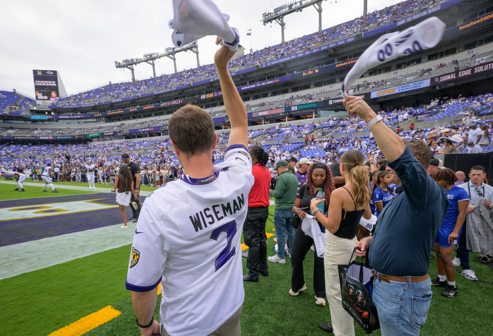 NASA astronaut and commander of the agency’s Artemis II mission, Reid Wiseman, a Baltimore native, left, waves a towel at an NFL game between the New Orleans Saints and the Baltimore Ravens at M&T Bank Stadium, Sunday, Sept. 20, 2026, in Baltimore. NASA’s engagement at NFL games is part of the agency's Inspiration Tour, aimed at strengthening connections between NASA and its partners and showcasing innovation in air and space in the lead up to the MAX POWER aerospace technology expo and airshow at the agency's Kennedy Space Center in early November. Photo Credit: (NASA/Bill Ingalls)