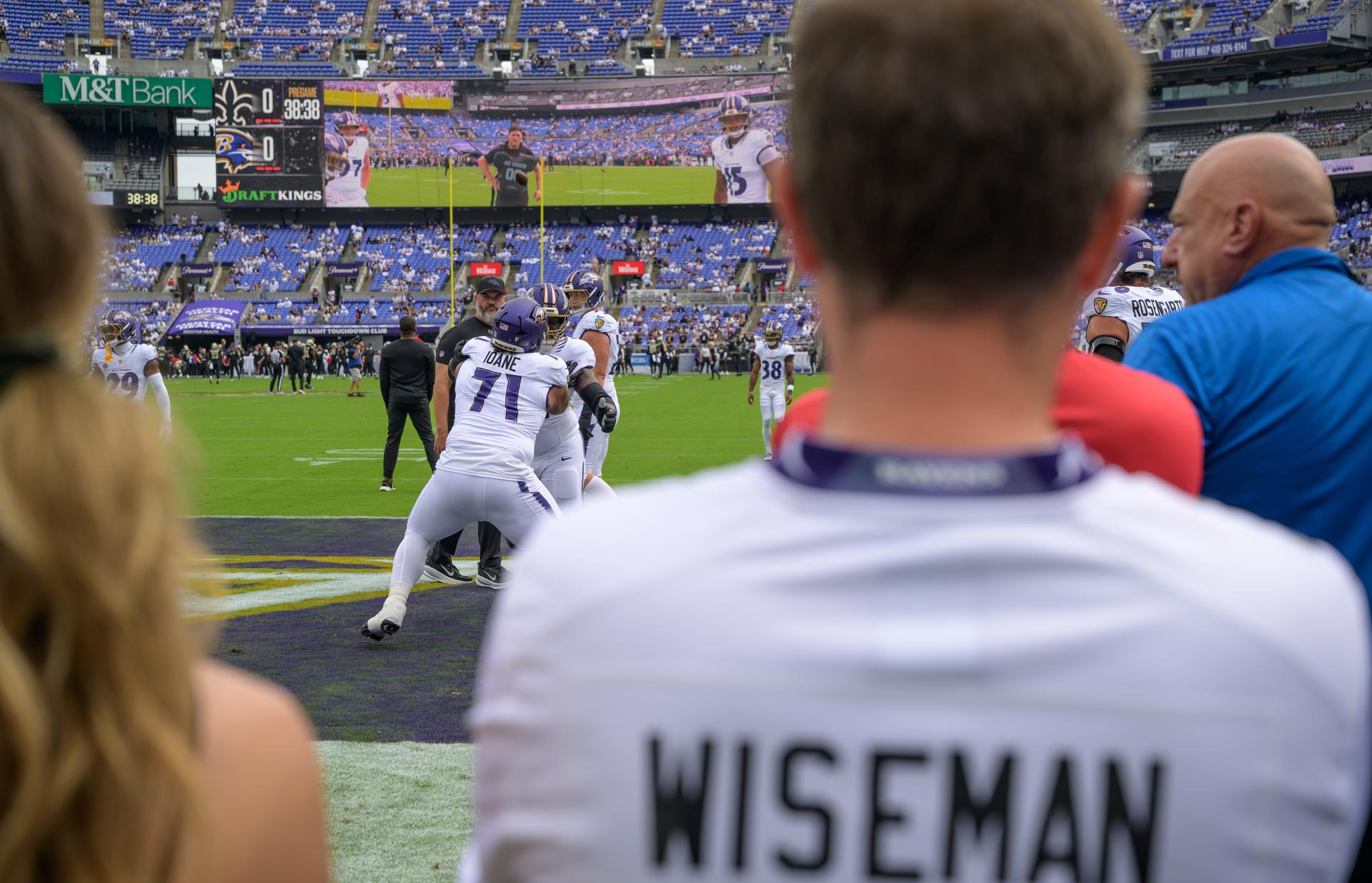 NASA astronaut and commander of the agency’s Artemis II mission, Reid Wiseman, a Baltimore native, watches as players warm up at an NFL game between the New Orleans Saints and the Baltimore Ravens at M&T Bank Stadium, Sunday, Sept. 20, 2026, in Baltimore. NASA’s engagement at NFL games is part of the agency's Inspiration Tour, aimed at strengthening connections between NASA and its partners and showcasing innovation in air and space in the lead up to the MAX POWER aerospace technology expo and airshow at the agency's Kennedy Space Center in early November. Photo Credit: (NASA/Bill Ingalls)