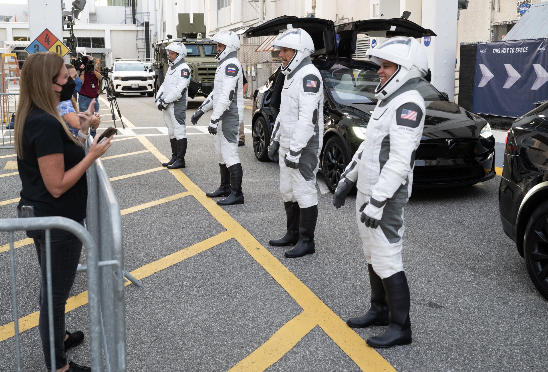 NASA astronauts Jessica Watkins, right, Luke Delaney, Roscosmos cosmonaut Sergey Teteryatnikov, and CSA (Canadian Space Agency) astronaut Joshua Kutryk, wearing SpaceX spacesuits, are seen as they prepare to depart the Neil  A. Armstrong Operations and Checkout Building for Space Launch Complex 40 on Cape Canaveral Space Force Station during a dress rehearsal prior to the Crew-13 mission launch, Tuesday, Sept. 29, 2026, at NASA’s Kennedy Space Center in Florida. NASA’s SpaceX Crew-13 mission is the 13th crew rotation mission of the SpaceX Dragon spacecraft and Falcon 9 rocket to the International Space Station as part of the agency’s Commercial Crew Program. Watkins, Delaney, Kutryk, Teteryatnikov are scheduled to launch at 11:10 a.m. EDT on Thursday, Oct. 1, from Space Launch Complex 40 at the Cape Canaveral Space Force Station. Photo Credit: (NASA/Joel Kowsky)