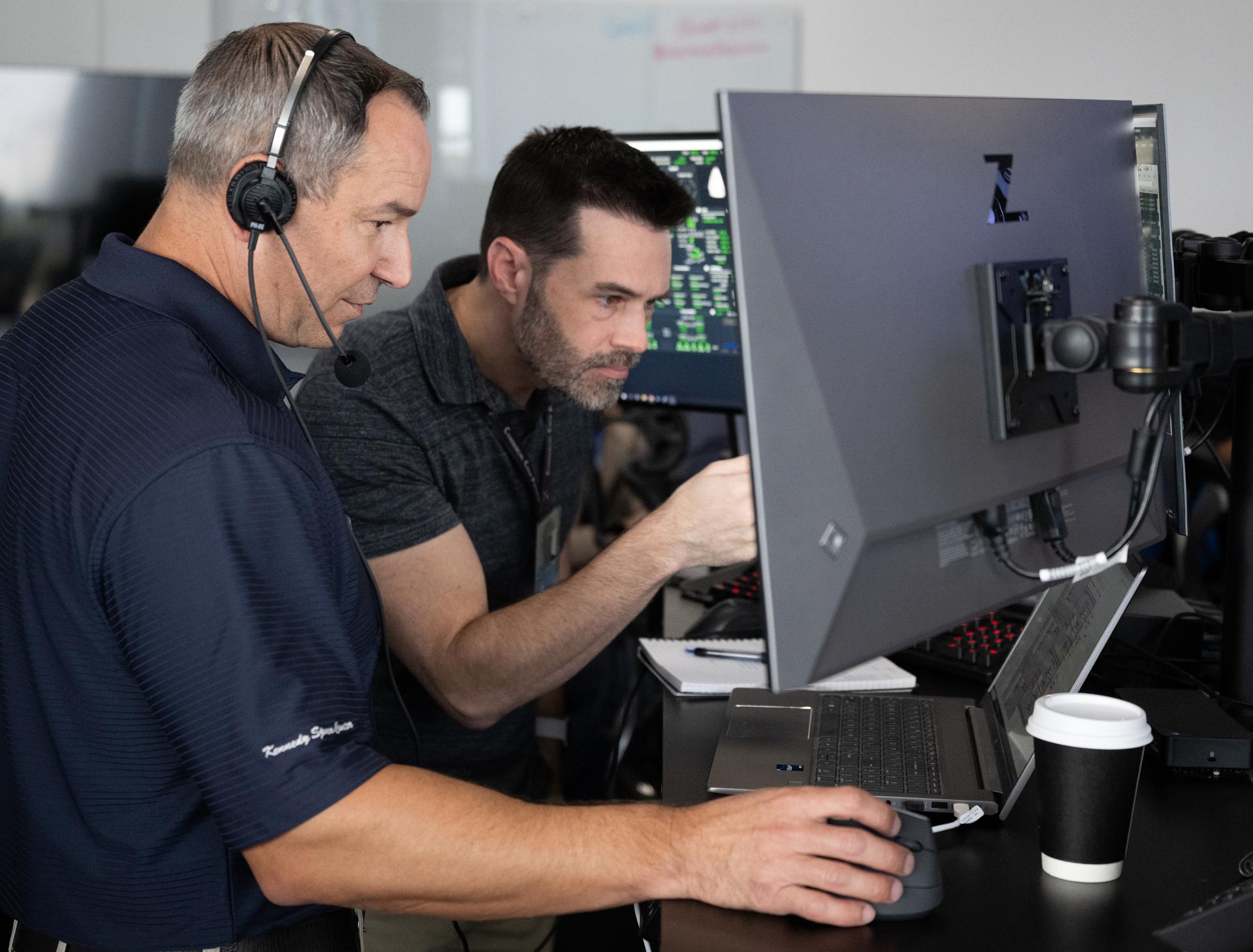 Kevin Vega, NASA’s Commercial Crew Program Chief Engineer, left, John Posey, lead engineer for Dragon in NASA's Commercial Crew Program are seen as they monitor the countdown during a dress rehearsal in preparation for the launch of a SpaceX Falcon 9 rocket carrying the company's Dragon spacecraft on NASA’s SpaceX Crew-13 mission with NASA astronauts Jessica Watkins and Luke Delaney, CSA (Canadian Space Agency) astronaut Joshua Kutryk, and Roscosmos cosmonaut Sergey Teteryatnikov onboard, Tuesday, Sept. 29, 2026, in the control room of SpaceX’s HangarX at NASA’s Kennedy Space Center in Florida. NASA’s SpaceX Crew-13 mission is the 13th crew rotation mission of the SpaceX Dragon spacecraft and Falcon 9 rocket to the International Space Station as part of the agency’s Commercial Crew Program. Watkins, Delaney, Kutryk, Teteryatnikov are scheduled to launch on 11:10 a.m. EDT on Thursday, Oct. 1, from Space Launch Complex 40 at the Cape Canaveral Space Force Station. Photo Credit: (NASA/Joel Kowsky)