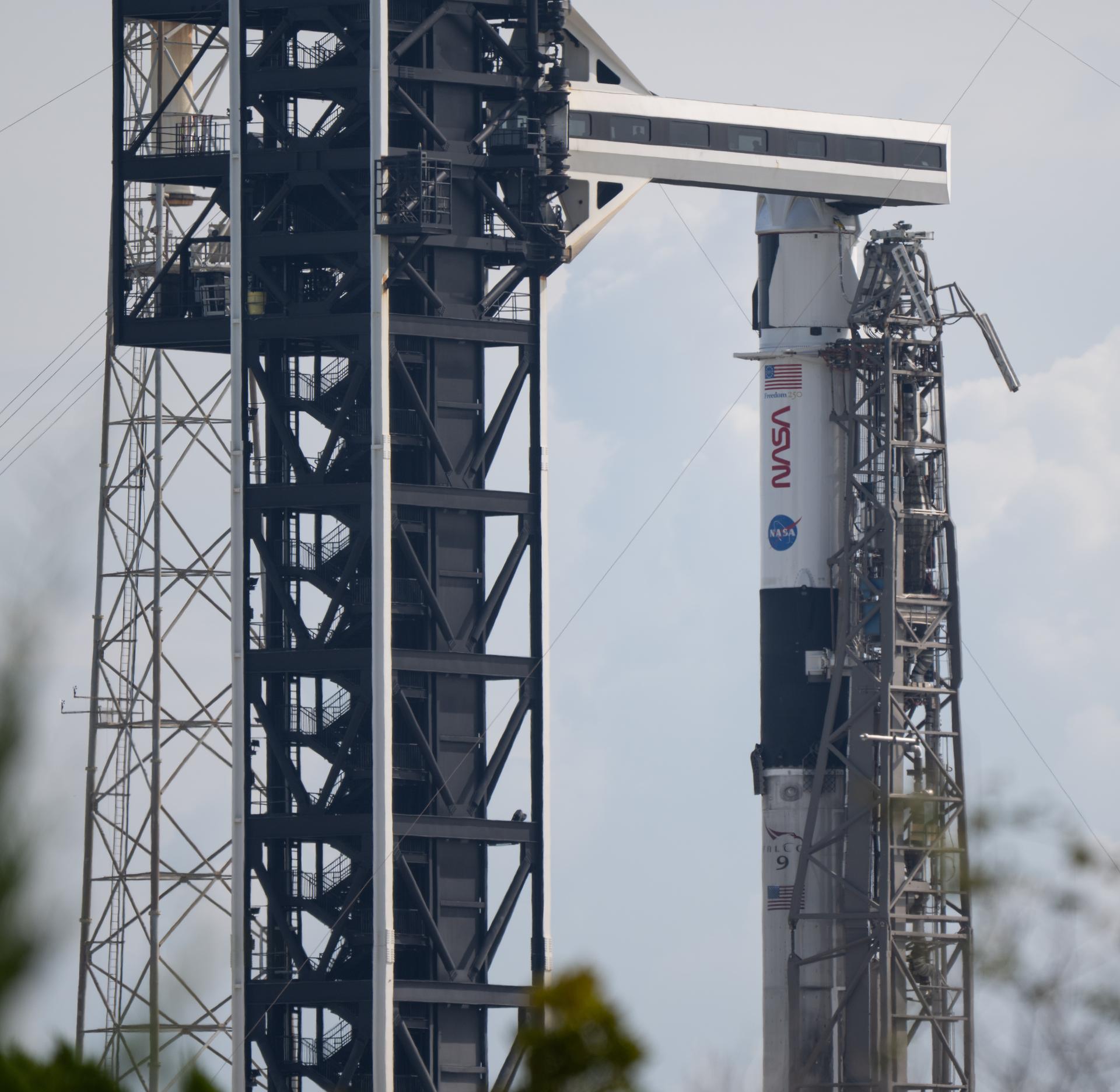 A SpaceX Falcon 9 rocket with the company's Dragon spacecraft on top is seen on the launch pad at Space Launch Complex 40 as preparations continue for the Crew-13 mission, Wednesday, Sept. 30, 2026, at Cape Canaveral Space Force Station in Florida. NASA’s SpaceX Crew-13 mission is the 13th crew rotation mission of the SpaceX Dragon spacecraft and Falcon 9 rocket to the International Space Station as part of the agency’s Commercial Crew Program. NASA astronauts Jessica Watkins and Luke Delaney, CSA (Canadian Space Agency) astronaut Joshua Kutryk, and Roscosmos cosmonaut Sergey Teteryatnikov are scheduled to launch at 11:10 a.m. EDT on Thursday, Oct. 1, from Space Launch Complex 40 at the Cape Canaveral Space Force Station. Photo Credit: (NASA/Joel Kowsky)