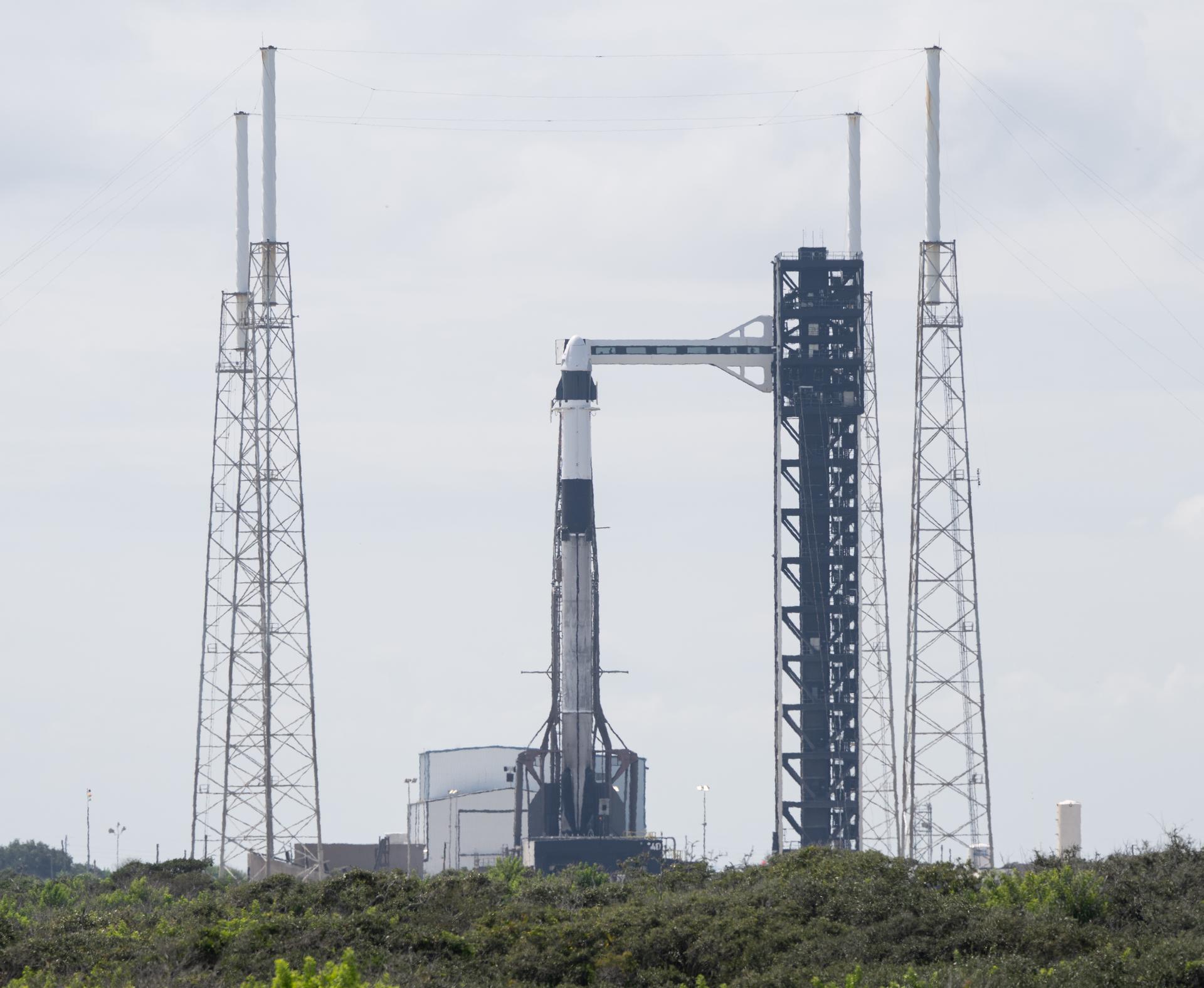 A SpaceX Falcon 9 rocket with the company's Dragon spacecraft on top is seen on the launch pad at Space Launch Complex 40 as preparations continue for the Crew-13 mission, Wednesday, Sept. 30, 2026, at Cape Canaveral Space Force Station in Florida. NASA’s SpaceX Crew-13 mission is the 13th crew rotation mission of the SpaceX Dragon spacecraft and Falcon 9 rocket to the International Space Station as part of the agency’s Commercial Crew Program. NASA astronauts Jessica Watkins and Luke Delaney, CSA (Canadian Space Agency) astronaut Joshua Kutryk, and Roscosmos cosmonaut Sergey Teteryatnikov are scheduled to launch at 11:10 a.m. EDT on Thursday, Oct. 1, from Space Launch Complex 40 at the Cape Canaveral Space Force Station. Photo Credit: (NASA/Joel Kowsky)