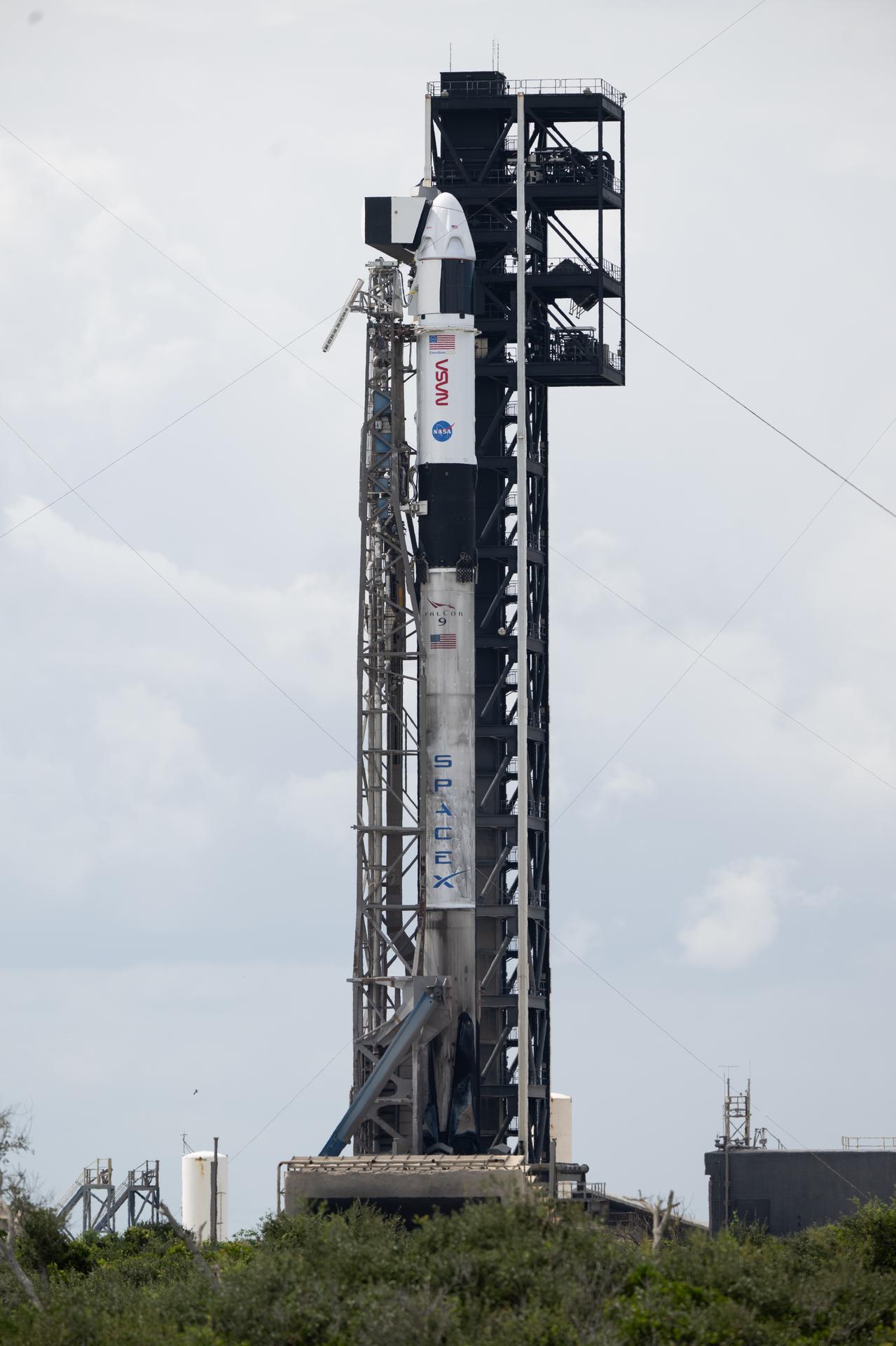 A SpaceX Falcon 9 rocket with the company's Dragon spacecraft on top is seen on the launch pad at Space Launch Complex 40 as preparations continue for the Crew-13 mission, Wednesday, Sept. 30, 2026, at Cape Canaveral Space Force Station in Florida. NASA’s SpaceX Crew-13 mission is the 13th crew rotation mission of the SpaceX Dragon spacecraft and Falcon 9 rocket to the International Space Station as part of the agency’s Commercial Crew Program. NASA astronauts Jessica Watkins and Luke Delaney, CSA (Canadian Space Agency) astronaut Joshua Kutryk, and Roscosmos cosmonaut Sergey Teteryatnikov are scheduled to launch at 11:10 a.m. EDT on Thursday, Oct. 1, from Space Launch Complex 40 at the Cape Canaveral Space Force Station. Photo Credit: (NASA/Joel Kowsky)