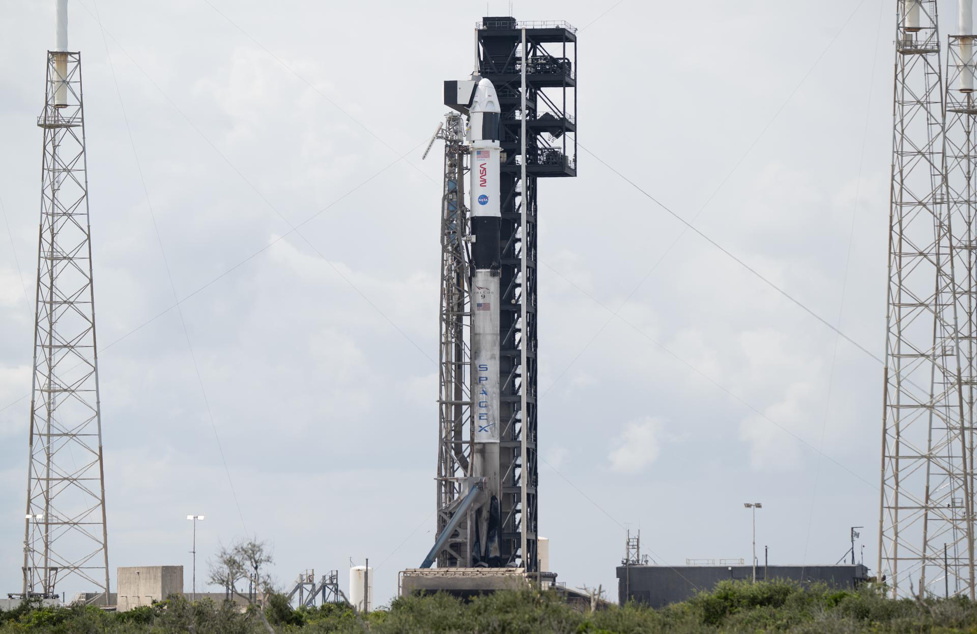 A SpaceX Falcon 9 rocket with the company's Dragon spacecraft on top is seen on the launch pad at Space Launch Complex 40 as preparations continue for the Crew-13 mission, Wednesday, Sept. 30, 2026, at Cape Canaveral Space Force Station in Florida. NASA’s SpaceX Crew-13 mission is the 13th crew rotation mission of the SpaceX Dragon spacecraft and Falcon 9 rocket to the International Space Station as part of the agency’s Commercial Crew Program. NASA astronauts Jessica Watkins and Luke Delaney, CSA (Canadian Space Agency) astronaut Joshua Kutryk, and Roscosmos cosmonaut Sergey Teteryatnikov are scheduled to launch at 11:10 a.m. EDT on Thursday, Oct. 1, from Space Launch Complex 40 at the Cape Canaveral Space Force Station. Photo Credit: (NASA/Joel Kowsky)