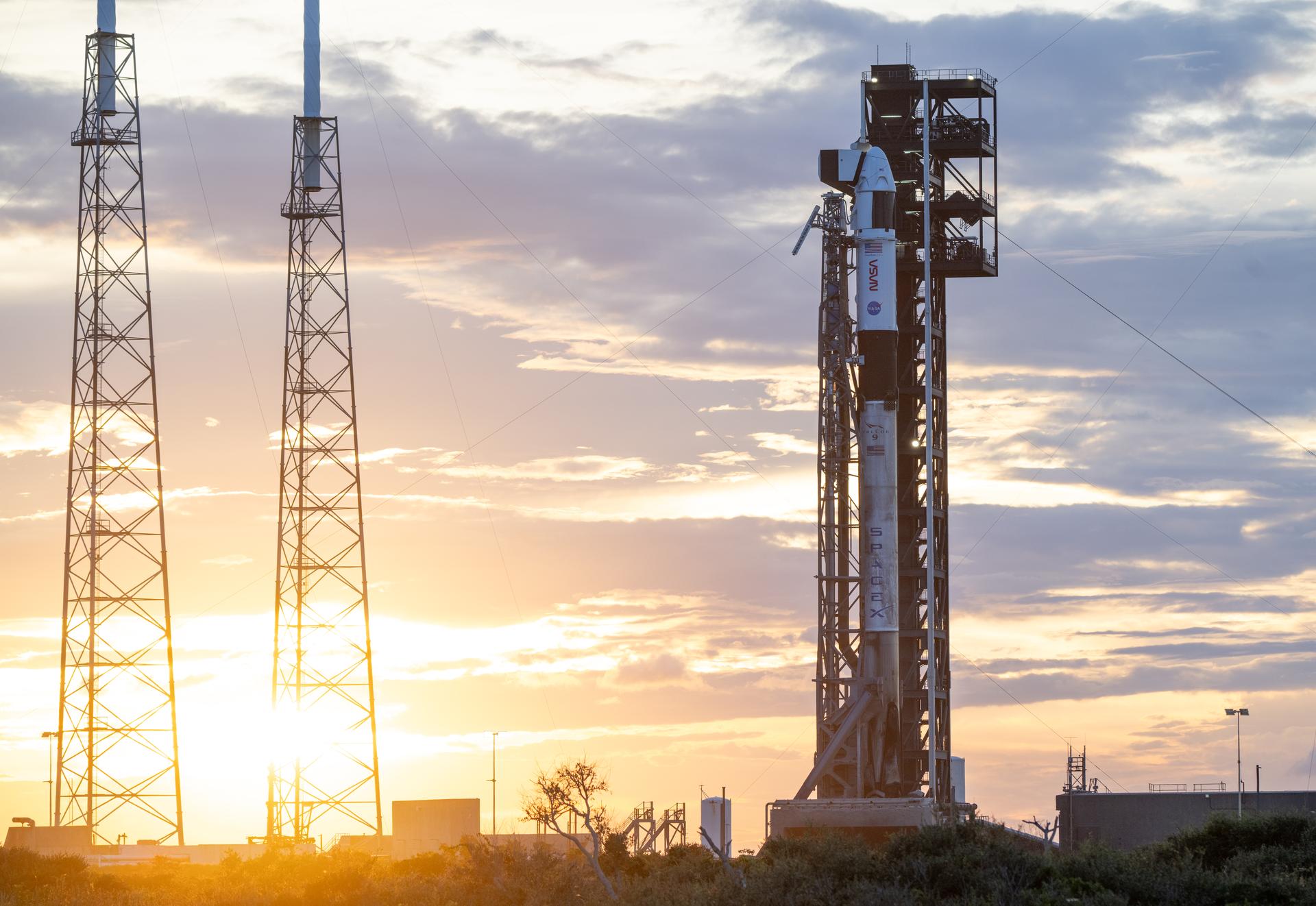 A SpaceX Falcon 9 rocket with the company's Dragon spacecraft on top is seen at sunset on the launch pad at Space Launch Complex 40 as preparations continue for the Crew-13 mission, Wednesday, Sept. 30, 2026, at Cape Canaveral Space Force Station in Florida. NASA’s SpaceX Crew-13 mission is the 13th crew rotation mission of the SpaceX Dragon spacecraft and Falcon 9 rocket to the International Space Station as part of the agency’s Commercial Crew Program. NASA astronauts Jessica Watkins and Luke Delaney, CSA (Canadian Space Agency) astronaut Joshua Kutryk, and Roscosmos cosmonaut Sergey Teteryatnikov are scheduled to launch at 11:10 a.m. EDT on Thursday, Oct. 1, from Space Launch Complex 40 at the Cape Canaveral Space Force Station. Photo Credit: (NASA/Joel Kowsky)