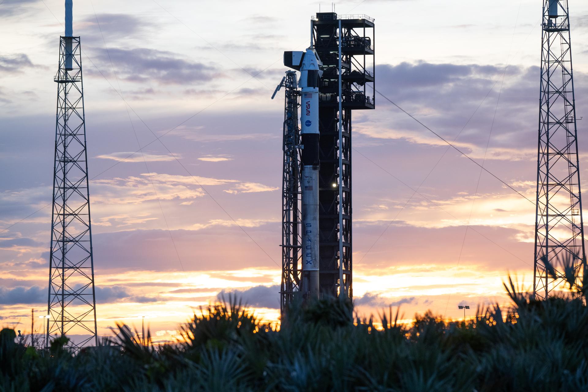 A SpaceX Falcon 9 rocket with the company's Dragon spacecraft on top is seen at sunset on the launch pad at Space Launch Complex 40 as preparations continue for the Crew-13 mission, Wednesday, Sept. 30, 2026, at Cape Canaveral Space Force Station in Florida. NASA’s SpaceX Crew-13 mission is the 13th crew rotation mission of the SpaceX Dragon spacecraft and Falcon 9 rocket to the International Space Station as part of the agency’s Commercial Crew Program. NASA astronauts Jessica Watkins and Luke Delaney, CSA (Canadian Space Agency) astronaut Joshua Kutryk, and Roscosmos cosmonaut Sergey Teteryatnikov are scheduled to launch at 11:10 a.m. EDT on Thursday, Oct. 1, from Space Launch Complex 40 at the Cape Canaveral Space Force Station. Photo Credit: (NASA/Joel Kowsky)