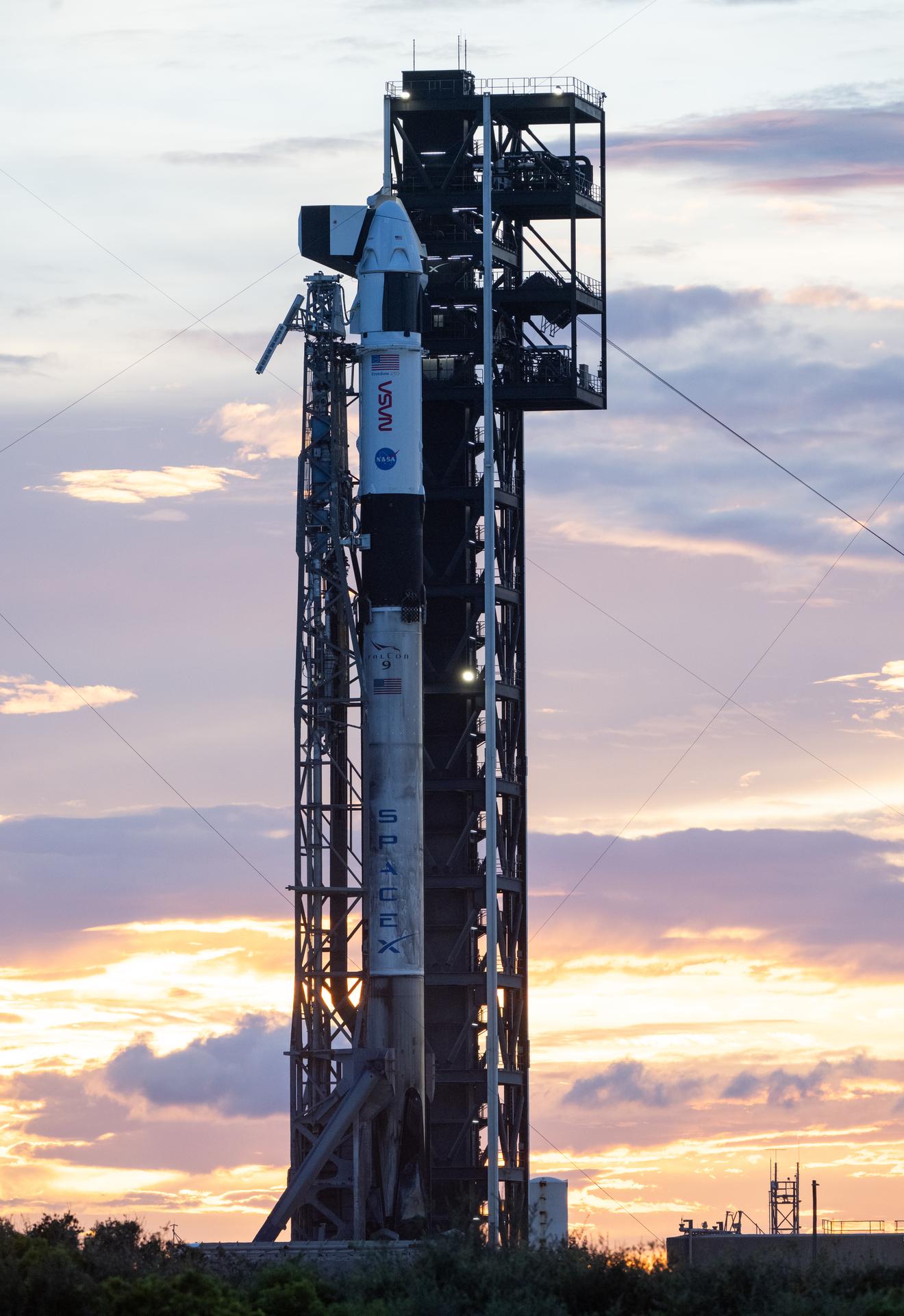 A SpaceX Falcon 9 rocket with the company's Dragon spacecraft on top is seen at sunset on the launch pad at Space Launch Complex 40 as preparations continue for the Crew-13 mission, Wednesday, Sept. 30, 2026, at Cape Canaveral Space Force Station in Florida. NASA’s SpaceX Crew-13 mission is the 13th crew rotation mission of the SpaceX Dragon spacecraft and Falcon 9 rocket to the International Space Station as part of the agency’s Commercial Crew Program. NASA astronauts Jessica Watkins and Luke Delaney, CSA (Canadian Space Agency) astronaut Joshua Kutryk, and Roscosmos cosmonaut Sergey Teteryatnikov are scheduled to launch at 11:10 a.m. EDT on Thursday, Oct. 1, from Space Launch Complex 40 at the Cape Canaveral Space Force Station. Photo Credit: (NASA/Joel Kowsky)