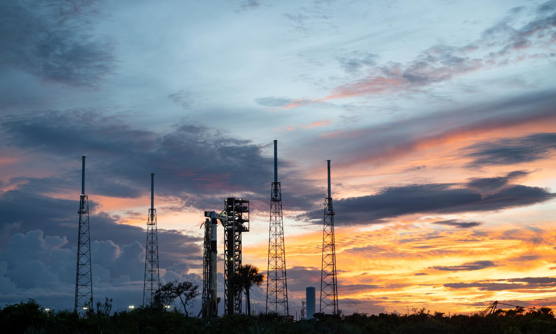 A SpaceX Falcon 9 rocket with the company's Dragon spacecraft on top is seen at sunset on the launch pad at Space Launch Complex 40 as preparations continue for the Crew-13 mission, Wednesday, Sept. 30, 2026, at Cape Canaveral Space Force Station in Florida. NASA’s SpaceX Crew-13 mission is the 13th crew rotation mission of the SpaceX Dragon spacecraft and Falcon 9 rocket to the International Space Station as part of the agency’s Commercial Crew Program. NASA astronauts Jessica Watkins and Luke Delaney, CSA (Canadian Space Agency) astronaut Joshua Kutryk, and Roscosmos cosmonaut Sergey Teteryatnikov are scheduled to launch at 11:10 a.m. EDT on Thursday, Oct. 1, from Space Launch Complex 40 at the Cape Canaveral Space Force Station. Photo Credit: (NASA/Joel Kowsky)
