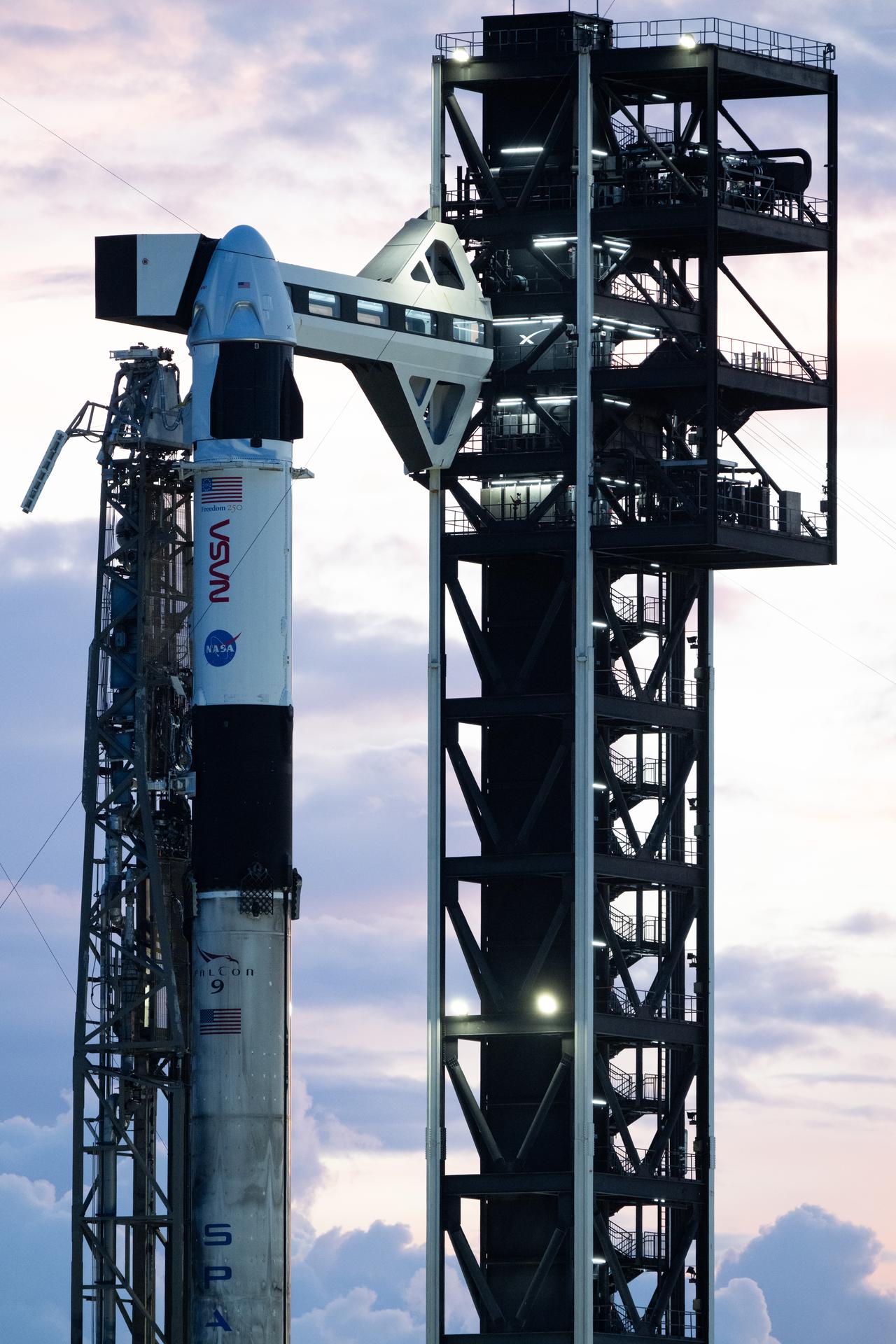 A SpaceX Falcon 9 rocket with the company's Dragon spacecraft on top is seen at sunset on the launch pad at Space Launch Complex 40 as preparations continue for the Crew-13 mission, Wednesday, Sept. 30, 2026, at Cape Canaveral Space Force Station in Florida. NASA’s SpaceX Crew-13 mission is the 13th crew rotation mission of the SpaceX Dragon spacecraft and Falcon 9 rocket to the International Space Station as part of the agency’s Commercial Crew Program. NASA astronauts Jessica Watkins and Luke Delaney, CSA (Canadian Space Agency) astronaut Joshua Kutryk, and Roscosmos cosmonaut Sergey Teteryatnikov are scheduled to launch at 11:10 a.m. EDT on Thursday, Oct. 1, from Space Launch Complex 40 at the Cape Canaveral Space Force Station. Photo Credit: (NASA/Joel Kowsky)
