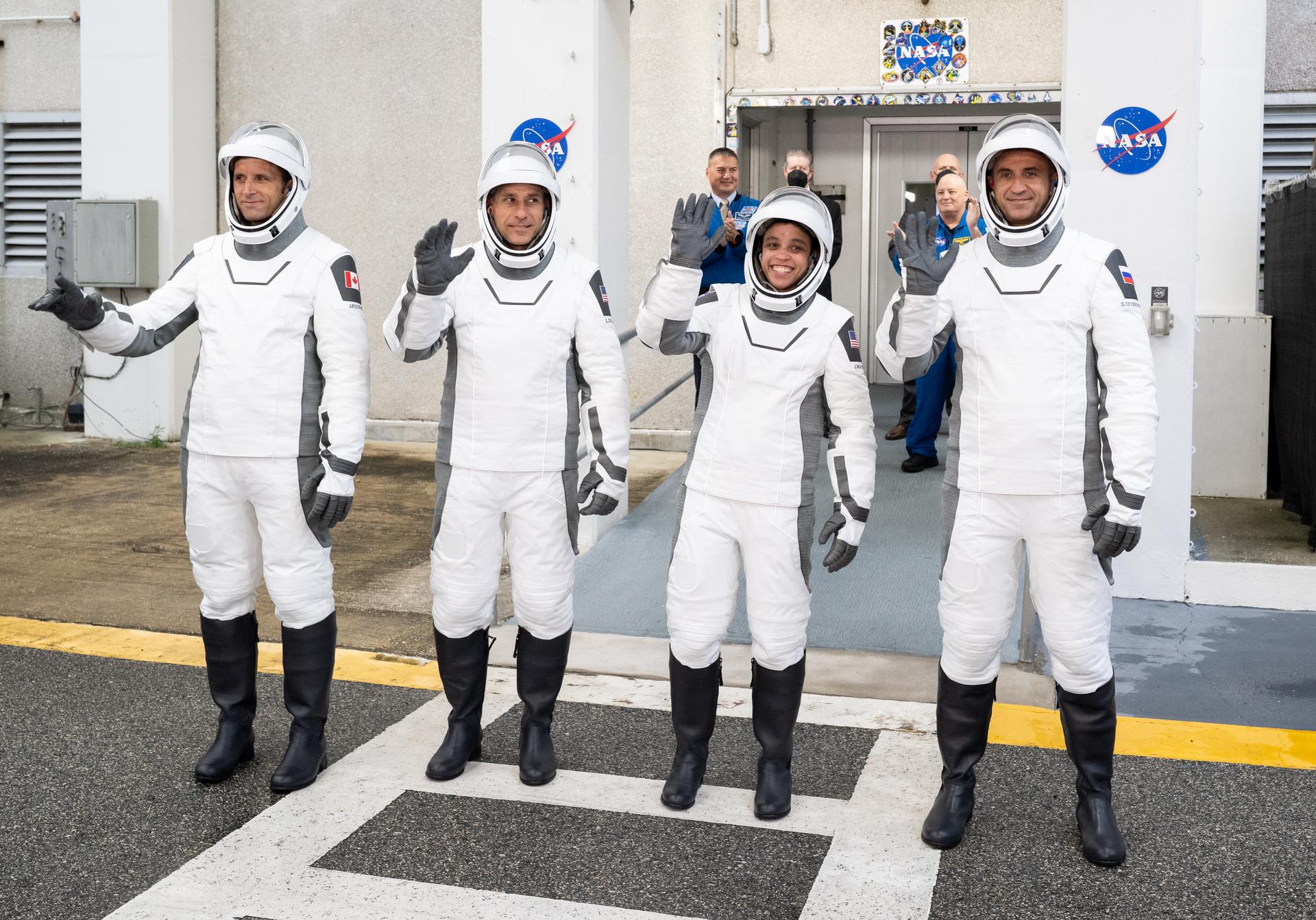 CSA (Canadian Space Agency) astronaut Joshua Kutryk, left, NASA astronauts Luke Delaney and Jessica Watkins, and Roscosmos cosmonaut Sergey Teteryatnikov, wearing SpaceX spacesuits, are seen as they prepare to depart the Neil  A. Armstrong Operations and Checkout Building for Space Launch Complex 40 on Cape Canaveral Space Force Station to board the SpaceX Dragon spacecraft for the Crew-13 mission launch, Thursday, Oct. 1, 2026, at NASA’s Kennedy Space Center in Florida. NASA’s SpaceX Crew-13 mission is the 13th crew rotation mission of the SpaceX Dragon spacecraft and Falcon 9 rocket to the International Space Station as part of the agency’s Commercial Crew Program. Watkins, Delaney, Kutryk, Teteryatnikov are scheduled to launch at 11:10 a.m. EDT, from Space Launch Complex 40 at the Cape Canaveral Space Force Station.  Photo Credit: (NASA/Joel Kowsky)