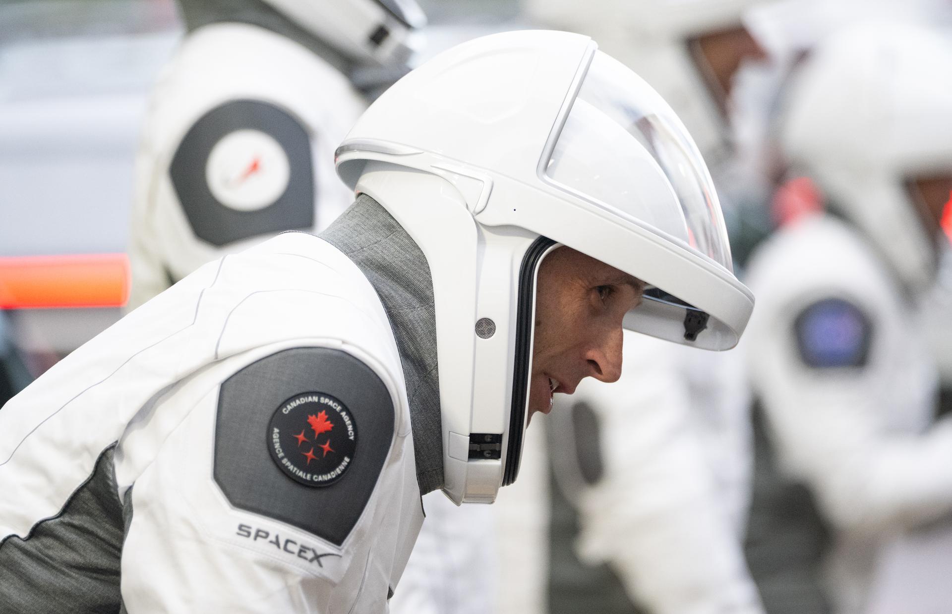 CSA (Canadian Space Agency) astronaut Joshua Kutryk is seen alongside fellow crewmates NASA astronauts Jessica Watkins, Luke Delaney, and Roscosmos cosmonaut Sergey Teteryatnikov, wearing SpaceX spacesuits, as they prepare to depart the Neil  A. Armstrong Operations and Checkout Building for Space Launch Complex 40 on Cape Canaveral Space Force Station to board the SpaceX Dragon spacecraft for the Crew-13 mission launch, Thursday, Oct. 1, 2026, at NASA’s Kennedy Space Center in Florida. NASA’s SpaceX Crew-13 mission is the 13th crew rotation mission of the SpaceX Crew Dragon spacecraft and Falcon 9 rocket to the International Space Station as part of the agency’s Commercial Crew Program. Watkins, Delaney, Kutryk, Teteryatnikov are scheduled to launch at 11:10 a.m. EDT, from Space Launch Complex 40 at the Cape Canaveral Space Force Station.  Photo Credit: (NASA/Joel Kowsky)