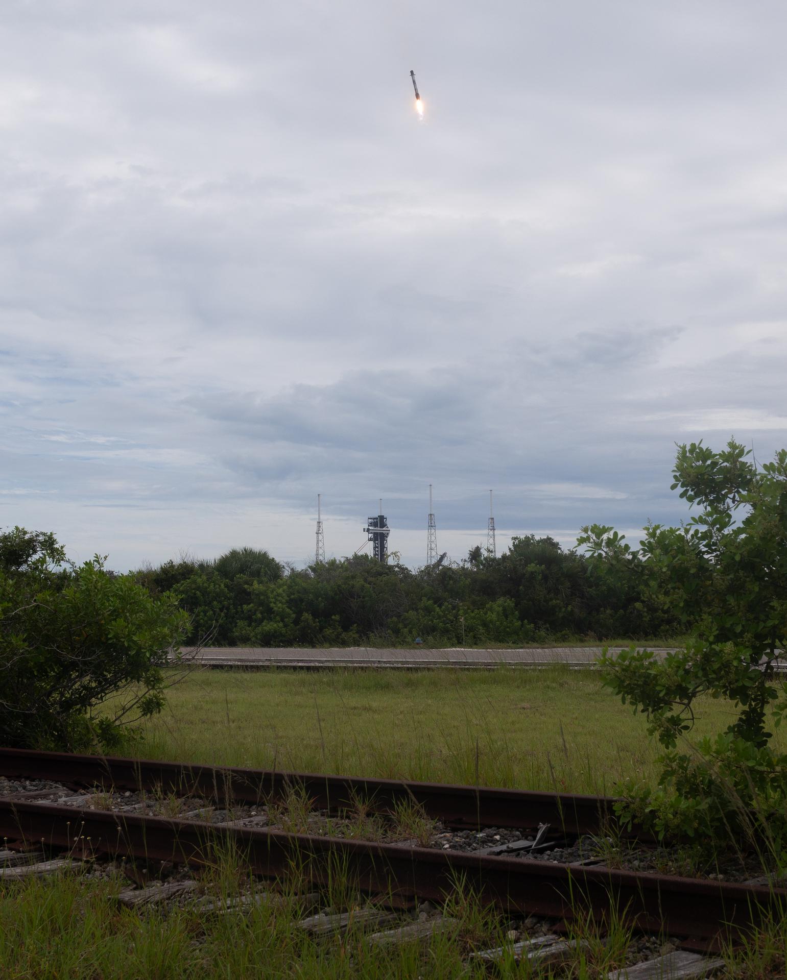 The first stage of the SpaceX Falcon 9 rocket that launched a Dragon spacecraft on NASA’s SpaceX Crew-13 mission to the International Space Station with NASA astronauts Jessica Watkins and Luke Delaney, CSA (Canadian Space Agency) astronaut Joshua Kutryk, and Roscosmos cosmonaut Sergey Teteryatnikov onboard, is seen as it lands at Space Launch Complex 40, Thursday, Oct. 1, 2026, from Cape Canaveral Space Force Station in Florida. NASA’s SpaceX Crew-13 mission is the 13th crew rotation mission of the SpaceX Dragon spacecraft and Falcon 9 rocket to the International Space Station as part of the agency’s Commercial Crew Program. Watkins, Delaney, Kutryk, Teteryatnikov launched at 11:10 a.m. EDT from Space Launch Complex 40 at the Cape Canaveral Space Force Station to begin a mission aboard the orbital outpost. Photo Credit: (NASA/Joel Kowsky)