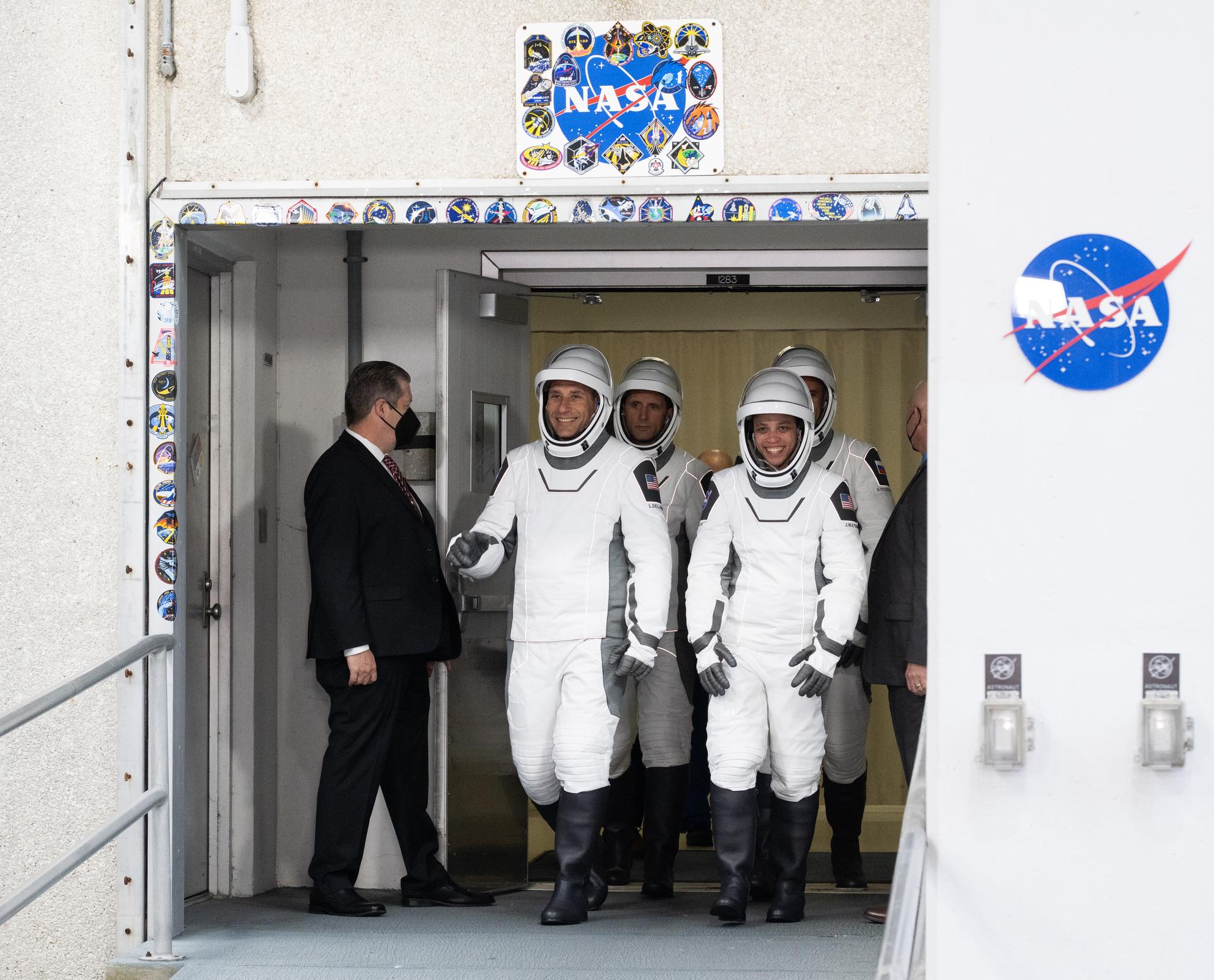 NASA astronauts Luke Delaney, front left, and Jessica Watkins, front right, CSA (Canadian Space Agency) astronaut Joshua Kutryk, back left, and Roscosmos cosmonaut Sergey Teteryatnikov, back right, wearing SpaceX spacesuits, are seen as they prepare to depart the Neil  A. Armstrong Operations and Checkout Building for Space Launch Complex 40 on Cape Canaveral Space Force Station to board the SpaceX Dragon spacecraft for the Crew-13 mission launch, Thursday, Oct. 1, 2026, at NASA’s Kennedy Space Center in Florida. NASA’s SpaceX Crew-13 mission is the 13th crew rotation mission of the SpaceX Dragon spacecraft and Falcon 9 rocket to the International Space Station as part of the agency’s Commercial Crew Program. Watkins, Delaney, Kutryk, Teteryatnikov are scheduled to launch at 11:10 a.m. EDT, from Space Launch Complex 40 at the Cape Canaveral Space Force Station.  Photo Credit: (NASA/Joel Kowsky)