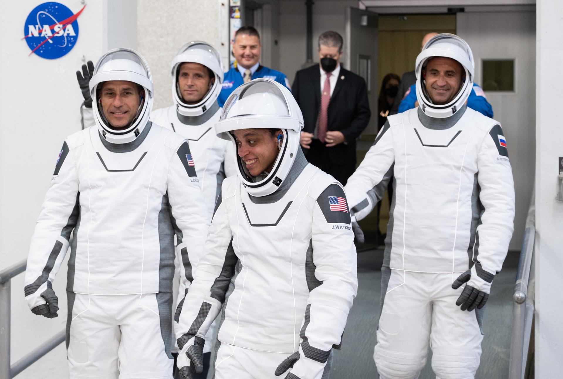 NASA astronauts Luke Delaney, front left, and Jessica Watkins, front right, CSA (Canadian Space Agency) astronaut Joshua Kutryk, back left, and Roscosmos cosmonaut Sergey Teteryatnikov, back right, wearing SpaceX spacesuits, are seen as they prepare to depart the Neil  A. Armstrong Operations and Checkout Building for Space Launch Complex 40 on Cape Canaveral Space Force Station to board the SpaceX Dragon spacecraft for the Crew-13 mission launch, Thursday, Oct. 1, 2026, at NASA’s Kennedy Space Center in Florida. NASA’s SpaceX Crew-13 mission is the 13th crew rotation mission of the SpaceX Dragon spacecraft and Falcon 9 rocket to the International Space Station as part of the agency’s Commercial Crew Program. Watkins, Delaney, Kutryk, Teteryatnikov are scheduled to launch at 11:10 a.m. EDT, from Space Launch Complex 40 at the Cape Canaveral Space Force Station.  Photo Credit: (NASA/Joel Kowsky)