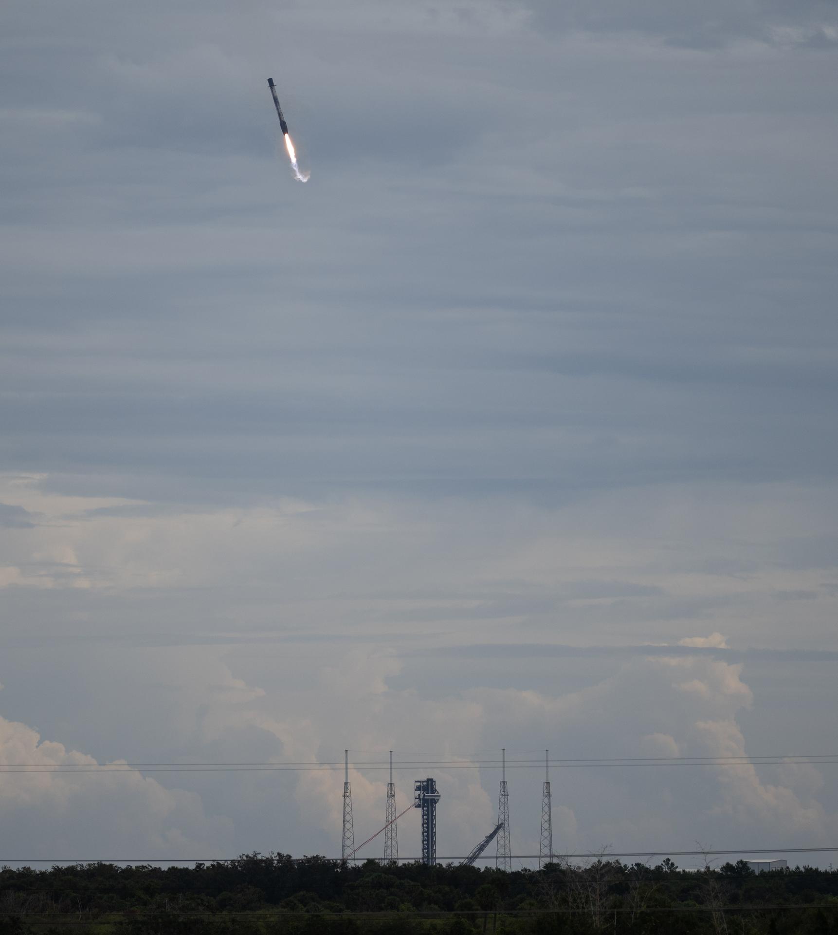 The first stage of the SpaceX Falcon 9 rocket that launched a Dragon spacecraft on NASA’s SpaceX Crew-13 mission to the International Space Station with NASA astronauts Jessica Watkins and Luke Delaney, CSA (Canadian Space Agency) astronaut Joshua Kutryk, and Roscosmos cosmonaut Sergey Teteryatnikov onboard, is seen as it lands at Space Launch Complex 40, Thursday, Oct. 1, 2026, from Cape Canaveral Space Force Station in Florida. NASA’s SpaceX Crew-13 mission is the 13th crew rotation mission of the SpaceX Dragon spacecraft and Falcon 9 rocket to the International Space Station as part of the agency’s Commercial Crew Program. Watkins, Delaney, Kutryk, Teteryatnikov launched at 11:10 a.m. EDT from Space Launch Complex 40 at the Cape Canaveral Space Force Station to begin a mission aboard the orbital outpost. Photo Credit: (NASA/Joel Kowsky)