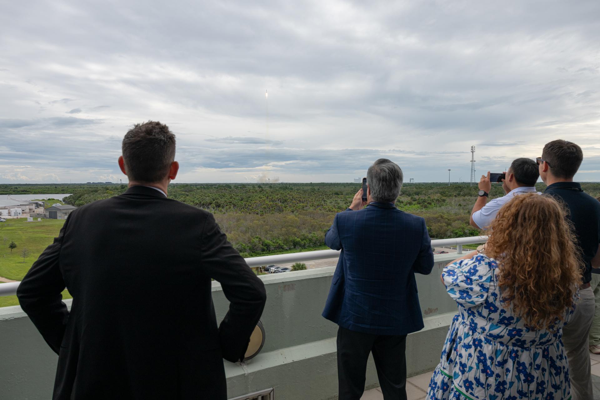 NASA Administrator Jared Isaacman, left, and invited guests and NASA employees watch as a SpaceX Falcon 9 rocket carrying the company’s Dragon spacecraft launches on NASA’s SpaceX Crew-13 mission to the International Space Station with NASA astronauts Jessica Watkins and Luke Delaney, CSA (Canadian Space Agency) astronaut Joshua Kutryk, and Roscosmos cosmonaut Sergey Teteryatnikov, Thursday, Oct. 1, 2026, at the Operations Support Building II at NASA’s Kennedy Space Center in Florida. NASA’s SpaceX Crew-13 mission is the thirteenth crew rotation mission of the SpaceX Falcon 9 rocket and Dragon spacecraft to the International Space Station as part of the agency’s Commercial Crew Program. Watkins, Delaney, Kutryk, and Teteryatnikov launched at 11:10 a.m. EDT from Space Launch Complex 40 at Cape Canaveral Space Force Station to begin their mission aboard the orbital outpost. Photo Credit: (NASA/John Kraus)