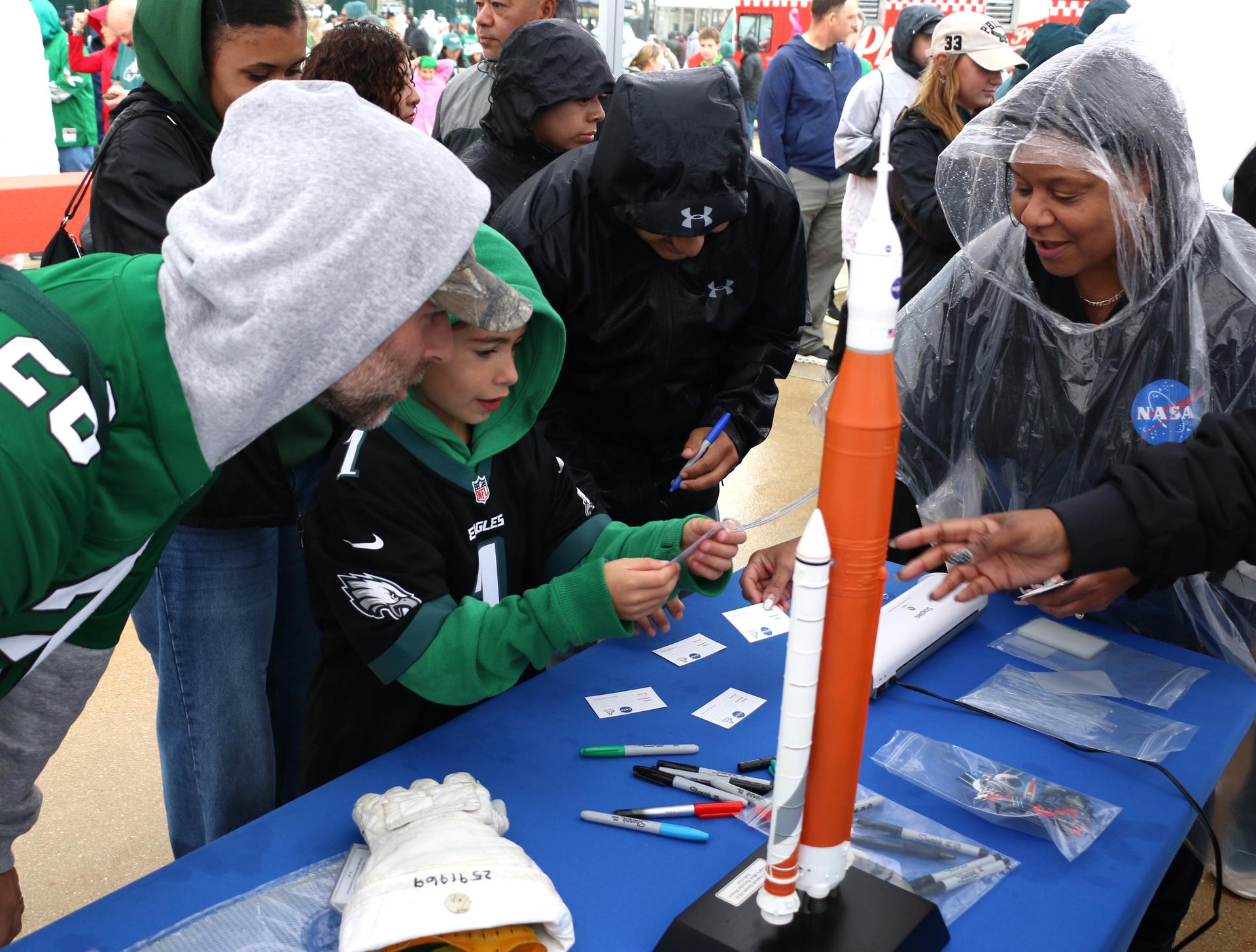 Fans participate at the NASA activation at the NFL game between the Philadelphia Eagles and the Los Angeles Rams at Lincoln Financial Field on Sunday, Oct. 4, 2026, in Philadelphia. NASA’s engagement at NFL games is part of the agency's Inspiration Tour, aimed at strengthening connections between NASA and its partners and showcasing innovation in air and space in the lead up to the MAX POWER aerospace technology expo and airshow at the agency's Kennedy Space Center in early November. Photo Credit: (NASA/Thalia Patrinos)