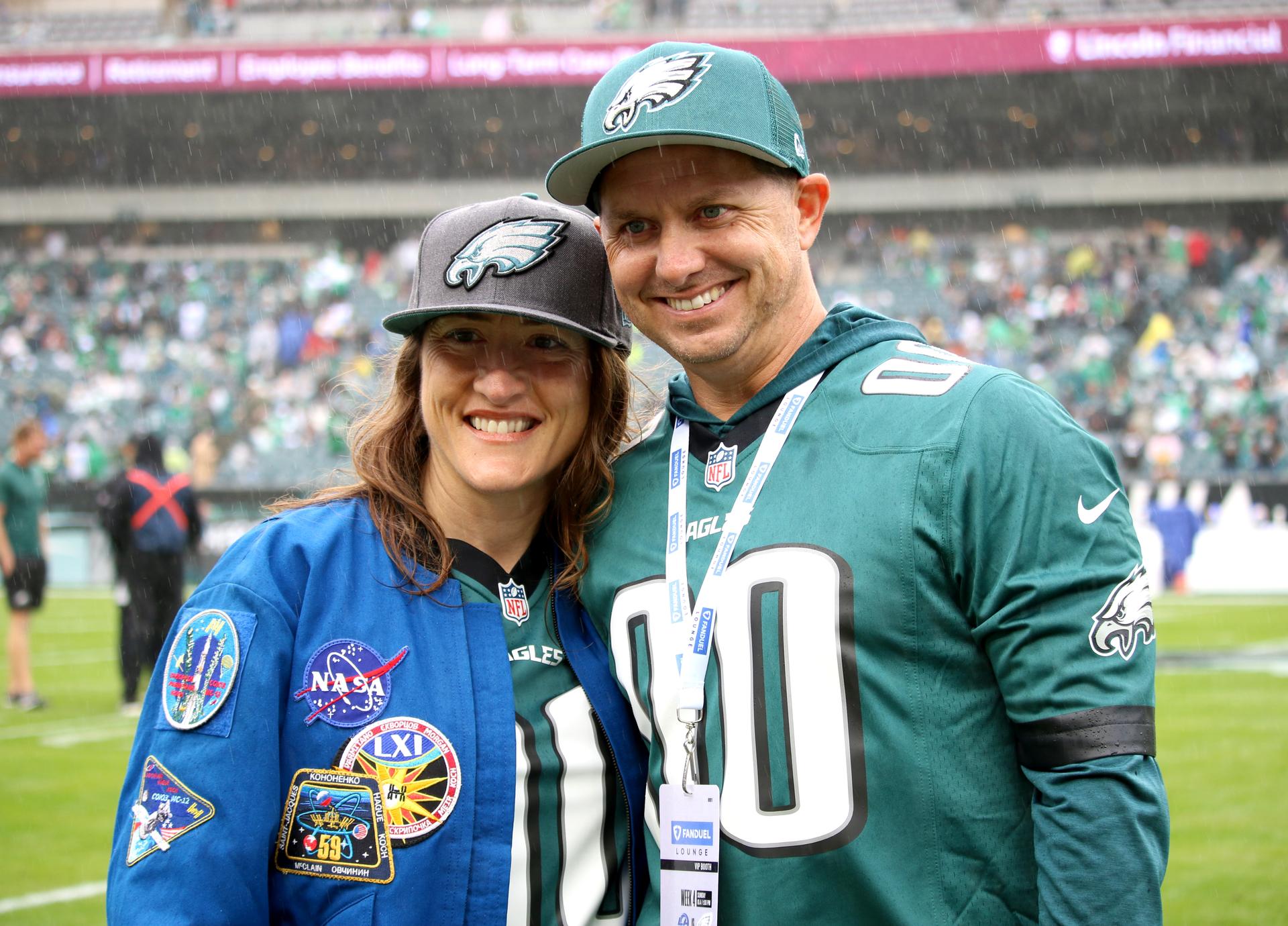 NASA astronaut and mission specialist of the agency's Artemis II mission, Christina Koch, and her husband, Robert Koch, pose at an NFL game between the Philadelphia Eagles and the Los Angeles Rams at Lincoln Financial Field on Sunday, Oct. 4, 2026, in Philadelphia. NASA’s engagement at NFL games is part of the agency's Inspiration Tour, aimed at strengthening connections between NASA and its partners and showcasing innovation in air and space in the lead up to the MAX POWER aerospace technology expo and airshow at the agency's Kennedy Space Center in early November. Photo Credit: (NASA/Thalia Patrinos)