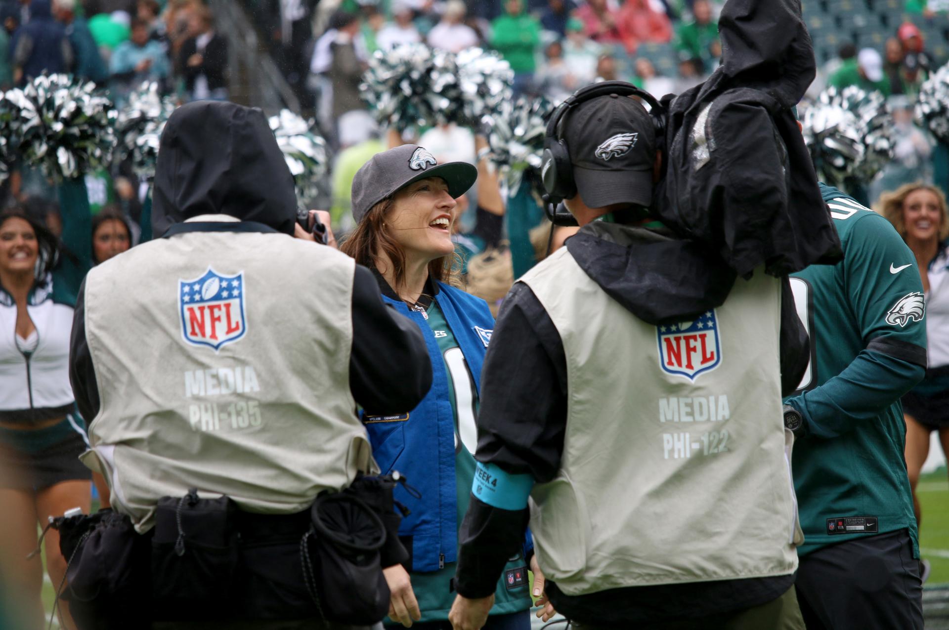 NASA astronaut and mission specialist of the agency's Artemis II mission, Christina Koch, lead the fans in singing the Eagles Fight Song from the field at an NFL game between the Philadelphia Eagles and the Los Angeles Rams at Lincoln Financial Field on Sunday, Oct. 4, 2026, in Philadelphia. NASA’s engagement at NFL games is part of the agency's Inspiration Tour, aimed at strengthening connections between NASA and its partners and showcasing innovation in air and space in the lead up to the MAX POWER aerospace technology expo and airshow at the agency's Kennedy Space Center in early November. Photo Credit: (NASA/Thalia Patrinos)