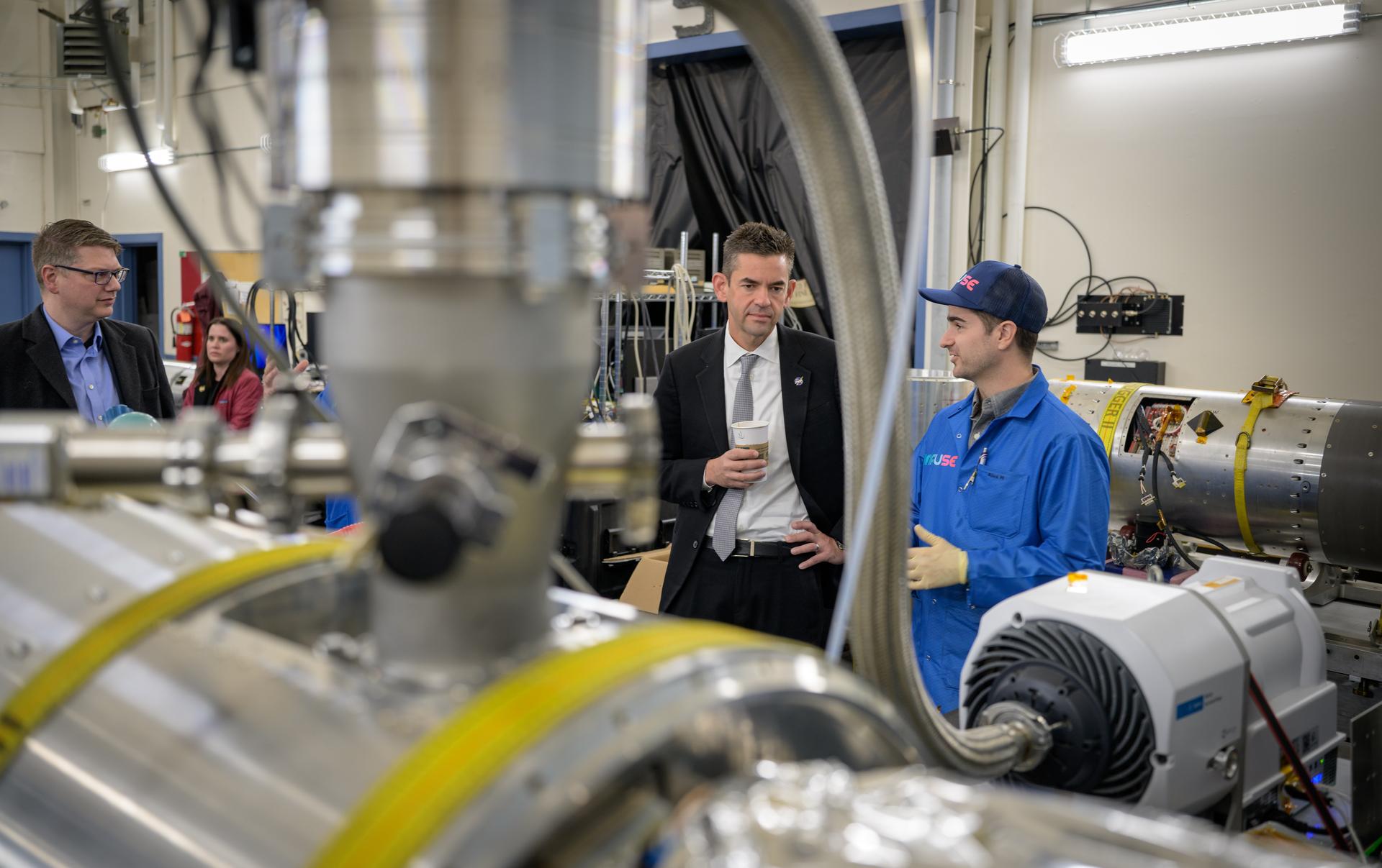 NASA Administrator Jared Isaacman, center, and Rep. Nick Begich, R-Alaska, left,  view the INtegral Field far-Ultraviolet Spectroscopic Experiment (INFUSE) and talk with employees at the Poker Flat Research Range, Monday, Oct. 5, 2026, in Fairbanks, Alaska. NASA’s visit to Alaska is part of the agency's Inspiration Tour, aimed at strengthening connections between NASA and its partners and showcasing innovation in air and space in the lead up to the MAX POWER aerospace technology expo and airshow at the agency's Kennedy Space Center in early November. Photo Credit: (NASA/Bill Ingalls)
