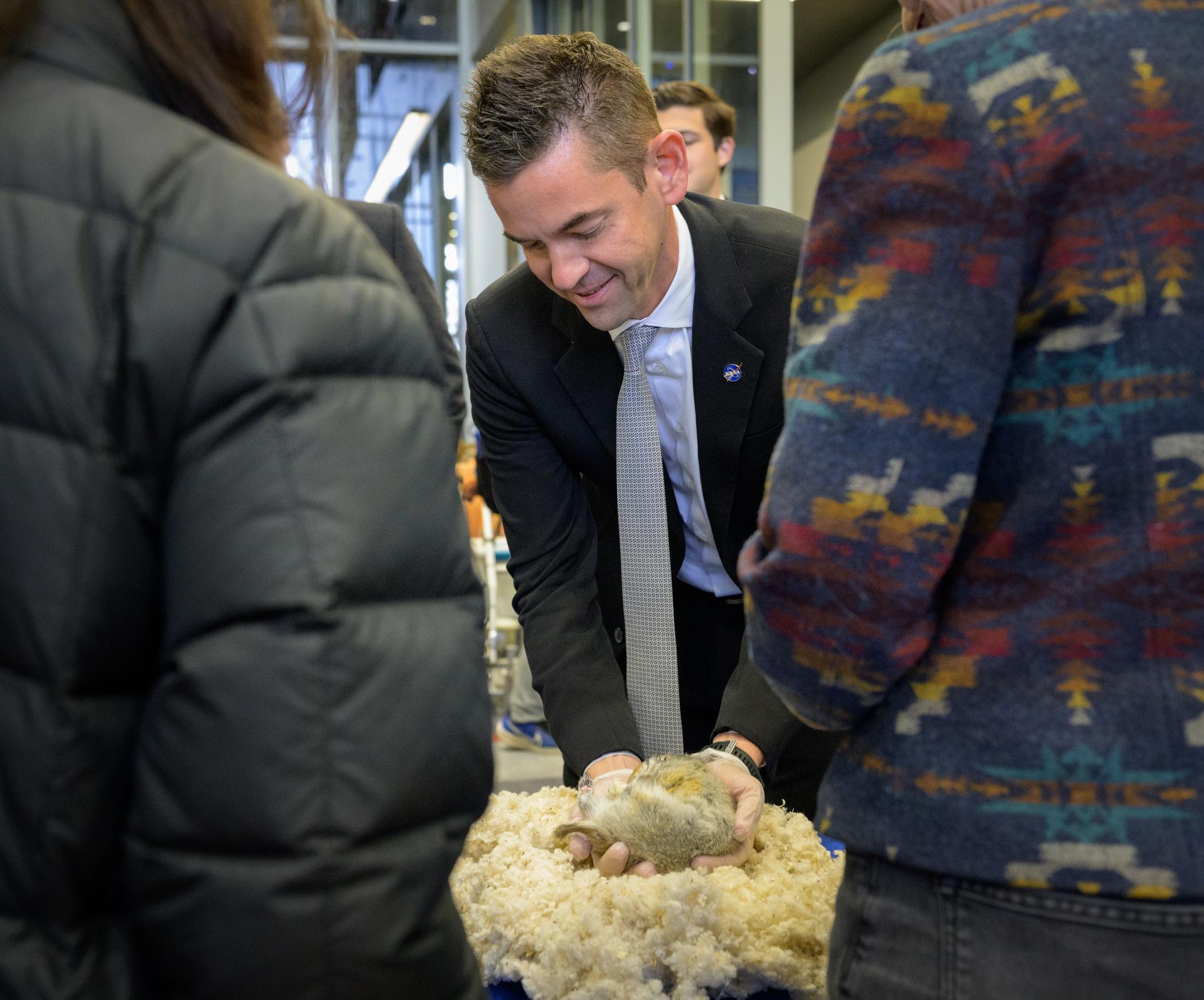 NASA Administrator Jared Isaacman holds a hibernating Arctic ground squirrel during a Space Grant Science Science Fare, Monday, Oct. 5, 2026, at the University of Alaska Fairbanks, in Fairbanks, Alaska. Hibernation is a naturally occurring phenomenon in ground squirrels and other species in which metabolic rate and core body temperature are drastically reduced for extended periods. The study looks at the ability of the squirrels to retain muscle and bone mass during extended hibernation and they think it could apply to astronauts. NASA’s visit to Alaska is part of the agency's Inspiration Tour, aimed at strengthening connections between NASA and its partners and showcasing innovation in air and space in the lead up to the MAX POWER aerospace technology expo and airshow at the agency's Kennedy Space Center in early November. Photo Credit: (NASA/Bill Ingalls)