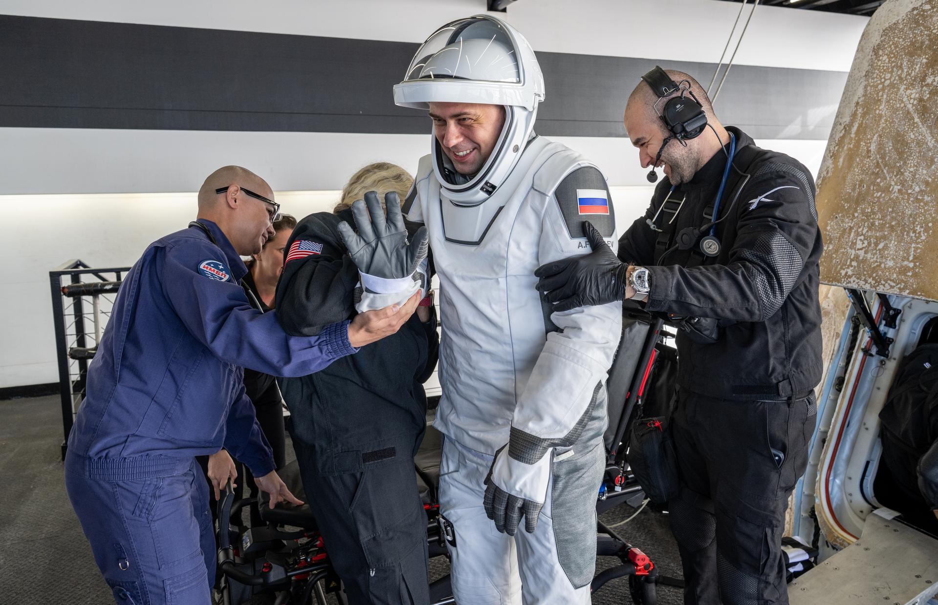 Roscosmos cosmonaut Andrey Fedyaev is helped out of the SpaceX Dragon Freedom spacecraft onboard the SpaceX recovery ship SHANNON after he, NASA astronauts Jack Hathaway, Jessica Meir, and ESA (European Space Agency) astronaut Sophie Adenot landed in the Pacific Ocean off the coast of Los Angeles, Calif., Thursday, Oct. 8, 2026. Meir, Hathaway, Adenot, and Fedyaev are returning after seven-months in space as part of Expedition 74 aboard the International Space Station. Photo Credit: (NASA/Keegan Barber)
