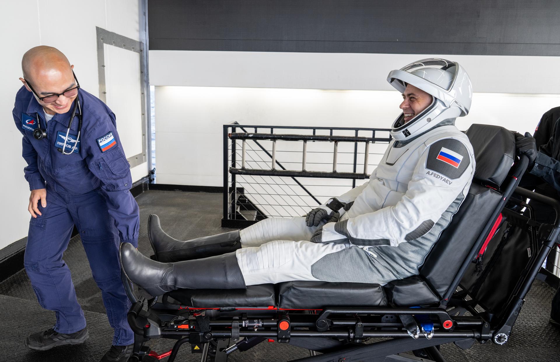 Roscosmos cosmonaut Andrey Fedyaev is helped out of the SpaceX Dragon Freedom spacecraft onboard the SpaceX recovery ship SHANNON after he, NASA astronauts Jack Hathaway, Jessica Meir, and ESA (European Space Agency) astronaut Sophie Adenot landed in the Pacific Ocean off the coast of Los Angeles, Calif., Thursday, Oct. 8, 2026. Meir, Hathaway, Adenot, and Fedyaev are returning after seven-months in space as part of Expedition 74 aboard the International Space Station. Photo Credit: (NASA/Keegan Barber)