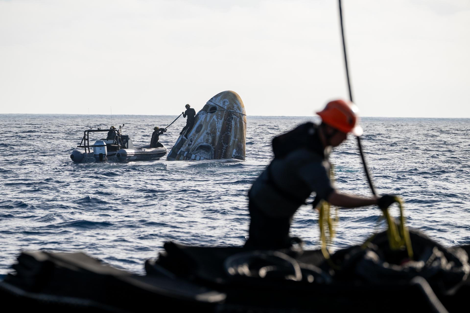 Support teams work around the SpaceX Dragon Freedom spacecraft shortly after it landed with NASA astronauts Jessica Meir, Jack Hathaway, ESA (European Space Agency) astronaut Sophie Adenot, and Roscosmos cosmonaut Andrey Fedyaev aboard in the Pacific Ocean off the coast of Los Angeles, Calif., Thursday, Oct. 8,2026. Meir, Hathaway, Adenot, and Fedyaev are returning after seven-months in space as part of Expedition 74 aboard the International Space Station. Photo Credit: (NASA/Keegan Barber)