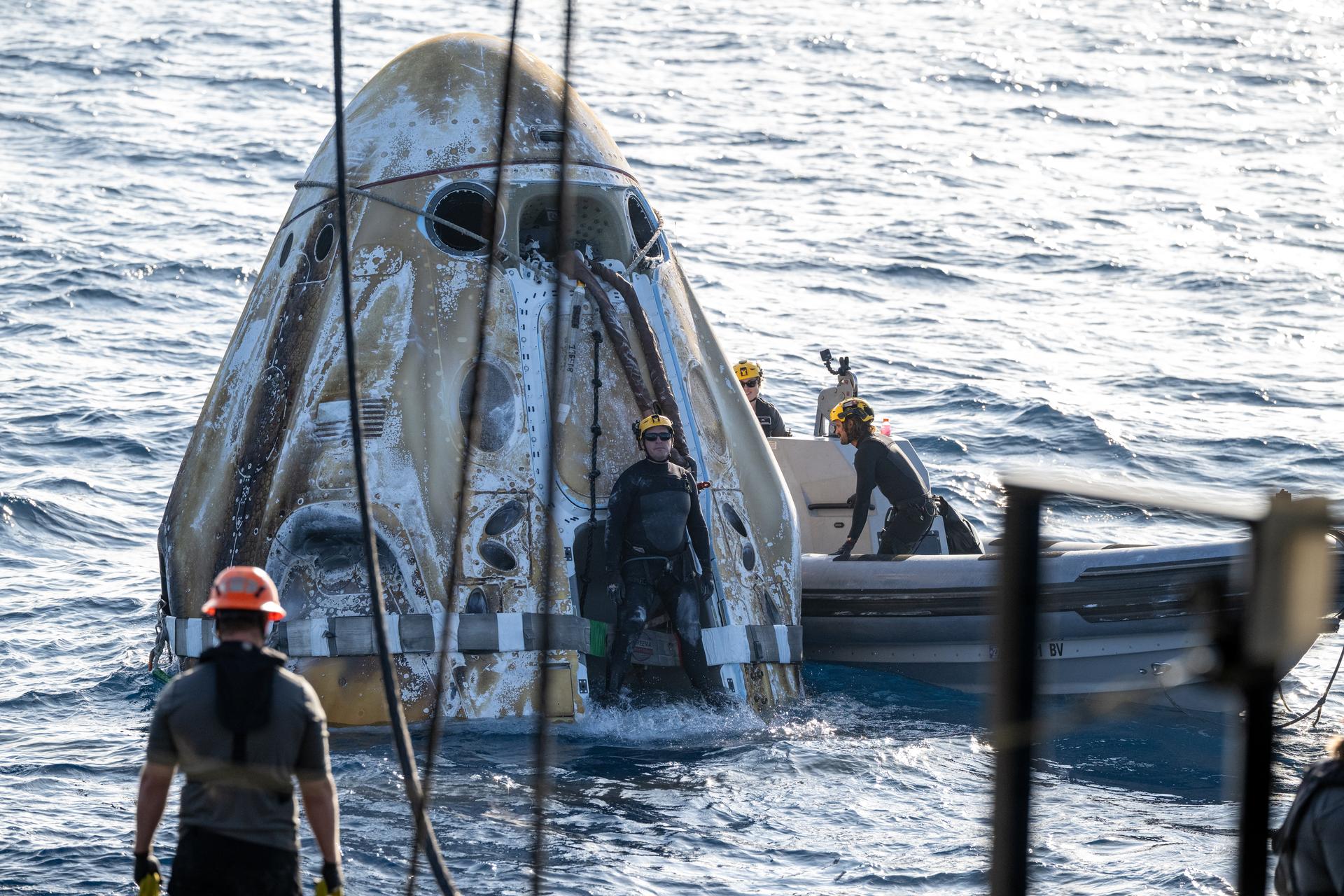 Support teams work around the SpaceX Dragon Freedom spacecraft shortly after it landed with NASA astronauts Jessica Meir, Jack Hathaway, ESA (European Space Agency) astronaut Sophie Adenot, and Roscosmos cosmonaut Andrey Fedyaev aboard in the Pacific Ocean off the coast of Los Angeles, Calif., Thursday, Oct. 8,2026. Meir, Hathaway, Adenot, and Fedyaev are returning after seven-months in space as part of Expedition 74 aboard the International Space Station. Photo Credit: (NASA/Keegan Barber)