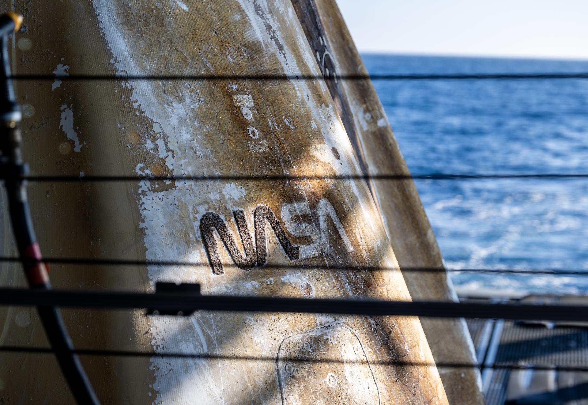 The NASA “Worm” logotype is seen as support teams onboard the SpaceX recovery ship SHANNON work around the SpaceX Dragon Freedom spacecraft shortly after it landed with NASA astronauts Jessica Meir, Jack Hathaway, ESA (European Space Agency) astronaut Sophie Adenot, and Roscosmos cosmonaut Andrey Fedyaev aboard in the Pacific Ocean off the coast of Los Angeles, Calif., Thursday, Oct. 8, 2026. Meir, Hathaway, Adenot, and Fedyaev are returning after seven-months in space as part of Expedition 74 aboard the International Space Station. Photo Credit: (NASA/Keegan Barber)