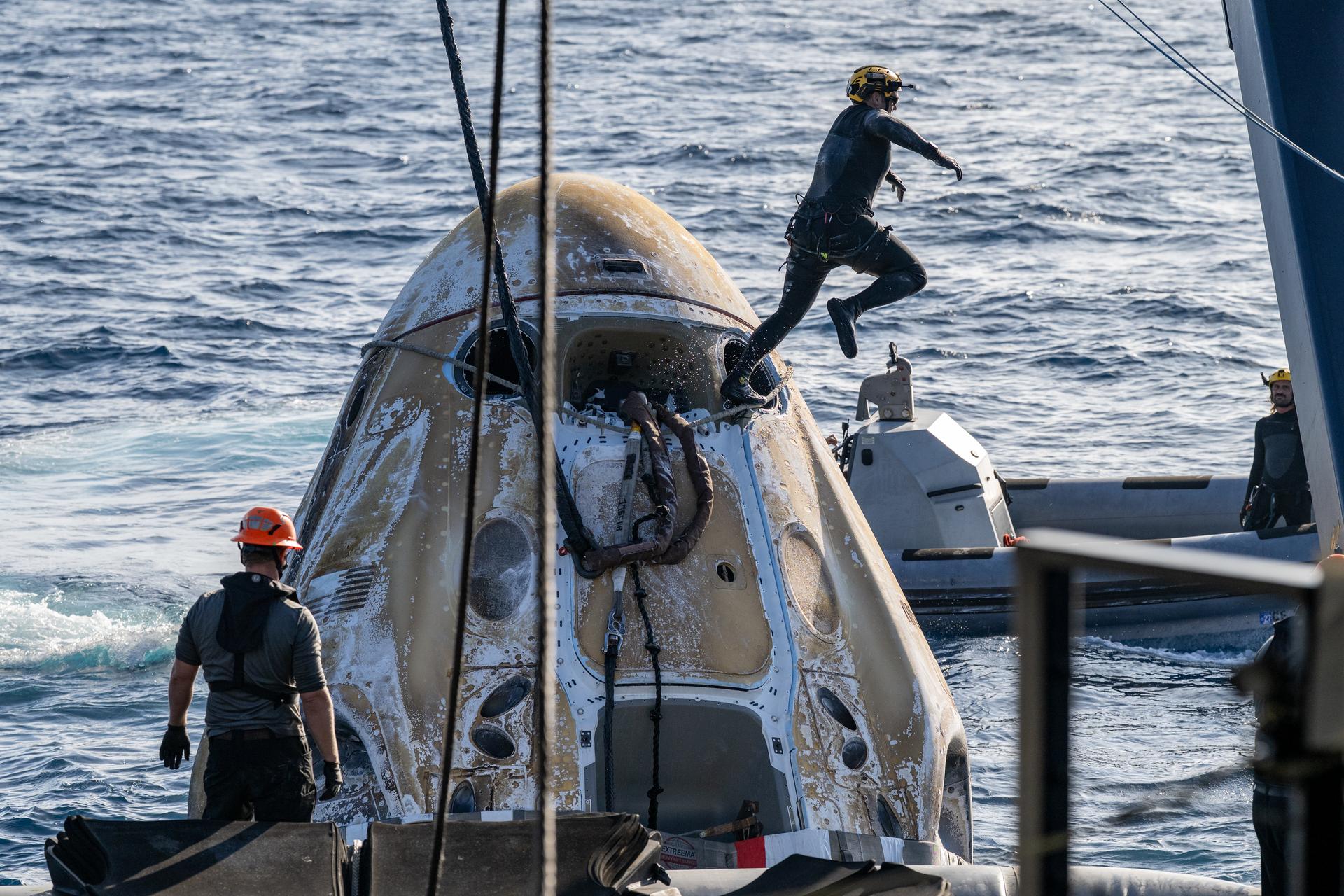 Support teams work around the SpaceX Dragon Freedom spacecraft shortly after it landed with NASA astronauts Jessica Meir, Jack Hathaway, ESA (European Space Agency) astronaut Sophie Adenot, and Roscosmos cosmonaut Andrey Fedyaev aboard in the Pacific Ocean off the coast of Los Angeles, Calif., Thursday, Oct. 8,2026. Meir, Hathaway, Adenot, and Fedyaev are returning after seven-months in space as part of Expedition 74 aboard the International Space Station. Photo Credit: (NASA/Keegan Barber)