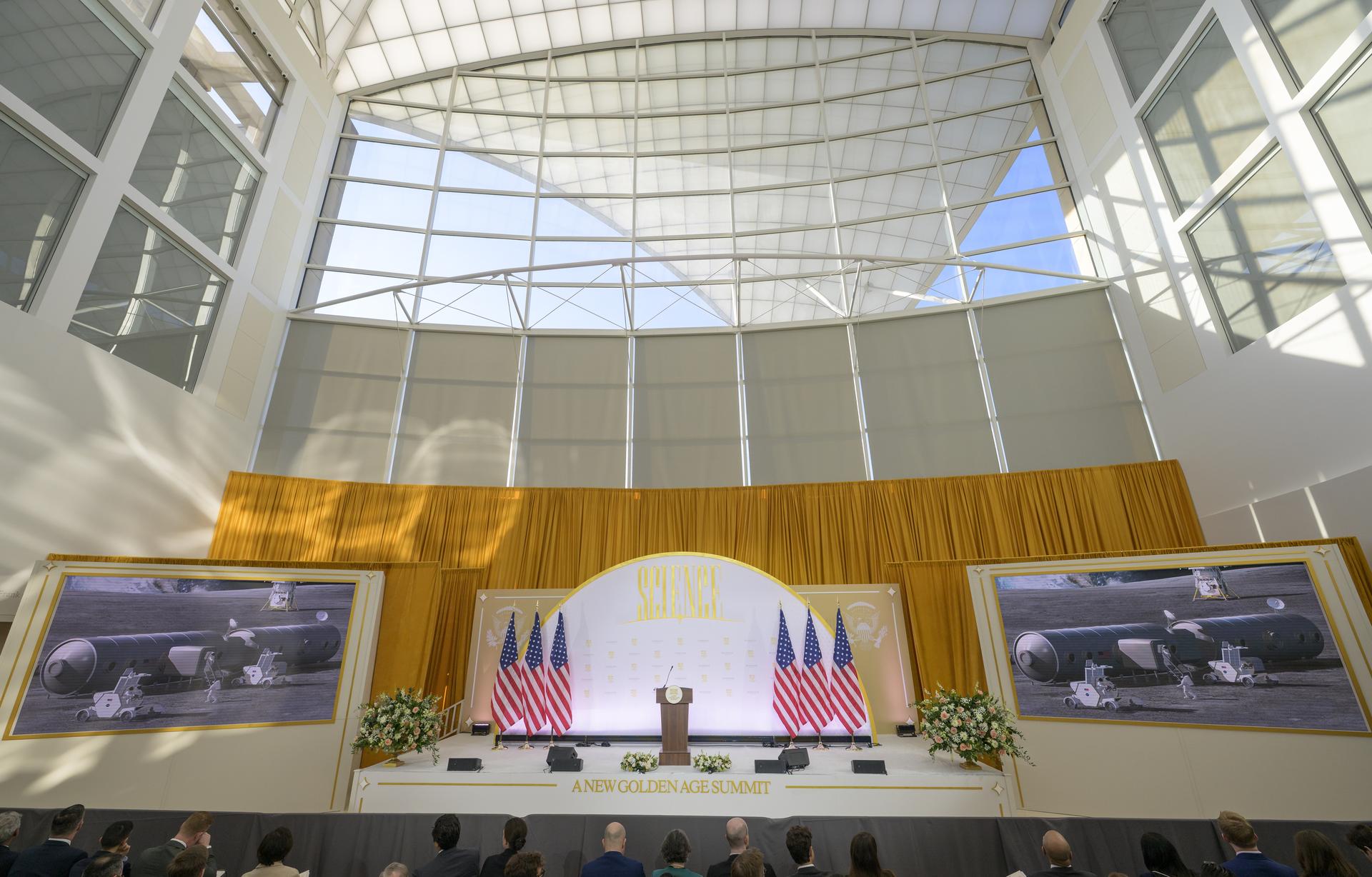 An introductory video, showing an artist concept of a Moon Base, is seen at the start of the the Golden Age Summit and the signing of a new Memorandum of Understanding between NASA and the Department of Energy, “Accelerating American Leadership in Space Nuclear Power and Propulsion”, Thursday, Oct. 8, 2026, at the Donald J. Trump Institute of Peace in Washington. Photo Credit: (NASA/Bill Ingalls)
