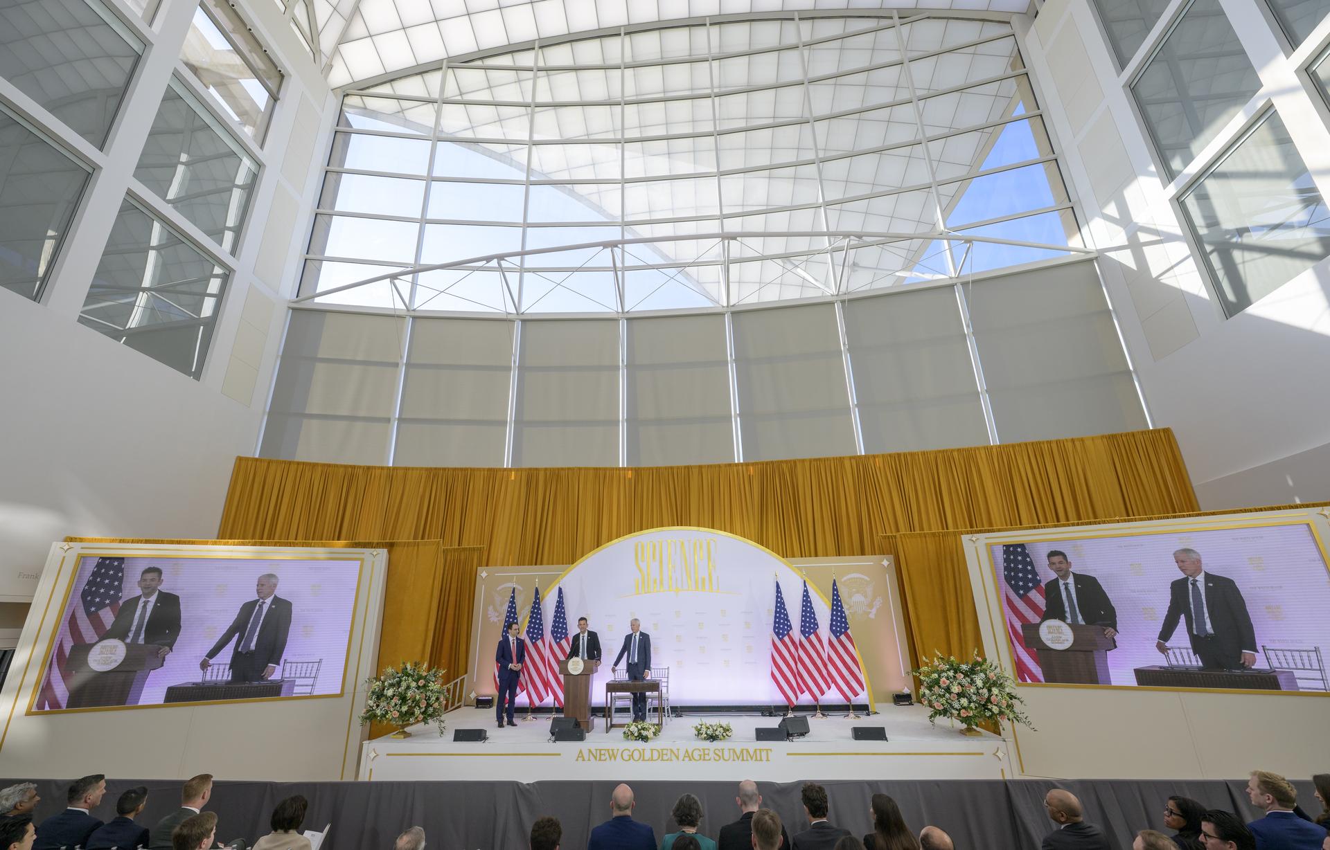 NASA Administrator Jared Isaacman, center, gives remarks with Director of the White House Office of Science and Technology Policy (OSTP) Michael Kratsios, left, and U.S. Secretary of Energy Chris Wright, ahead of NASA and DOE signing a new Memorandum of Understanding, “Accelerating American Leadership in Space Nuclear Power and Propulsion”, during the Golden Age Summit, Thursday, Oct. 8, 2026, at the Donald J. Trump Institute of Peace in Washington. Photo Credit: (NASA/Bill Ingalls)