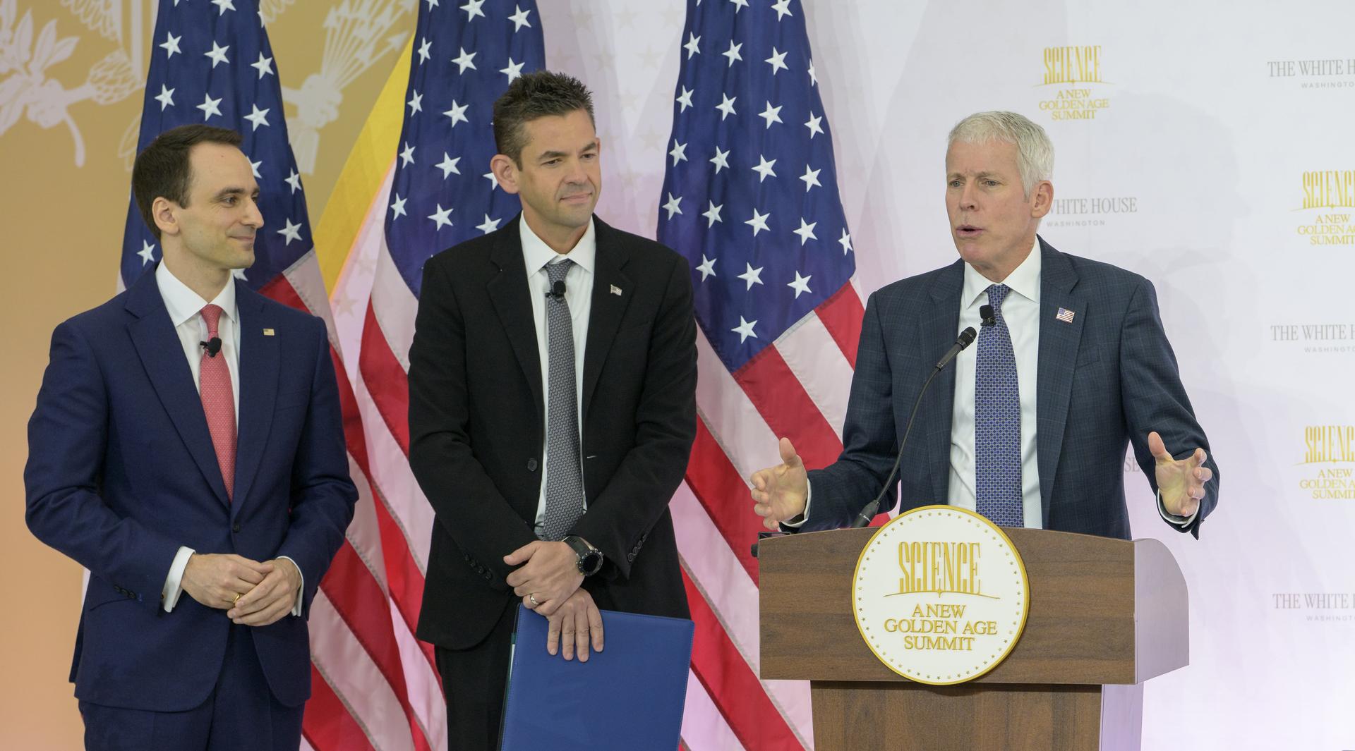 U.S. Secretary of Energy Chris Wright, right, gives remarks with Director of the White House Office of Science and Technology Policy (OSTP) Michael Kratsios, left, and NASA Administrator Jared Isaacman, ahead of NASA and DOE signing a new Memorandum of Understanding, “Accelerating American Leadership in Space Nuclear Power and Propulsion”, during the Golden Age Summit, Thursday, Oct. 8, 2026, at the Donald J. Trump Institute of Peace in Washington. Photo Credit: (NASA/Bill Ingalls)