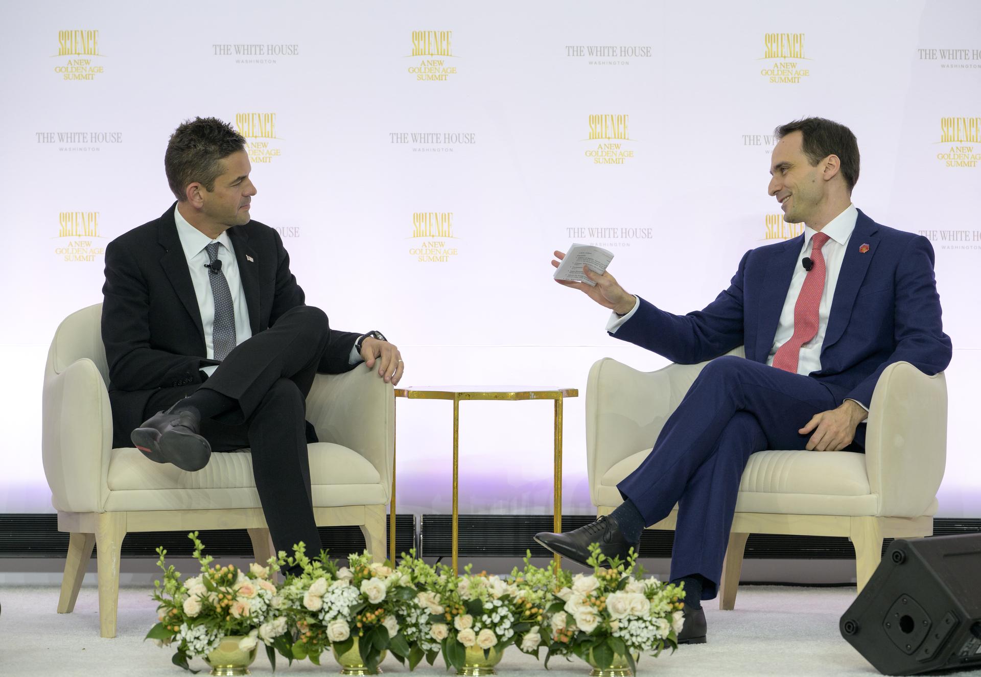 NASA Administrator Jared Isaacman, left, participates in a fireside chat with Director of the White House Office of Science and Technology Policy (OSTP) Michael Kratsios during the Golden Age Summit, Thursday, Oct. 8, 2026, at the Donald J. Trump Institute of Peace in Washington. Photo Credit: (NASA/Bill Ingalls)