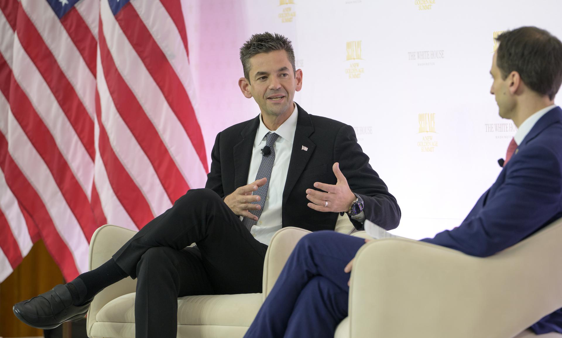 NASA Administrator Jared Isaacman, left, participates in a fireside chat with Director of the White House Office of Science and Technology Policy (OSTP) Michael Kratsios during the Golden Age Summit, Thursday, Oct. 8, 2026, at the Donald J. Trump Institute of Peace in Washington. Photo Credit: (NASA/Bill Ingalls)