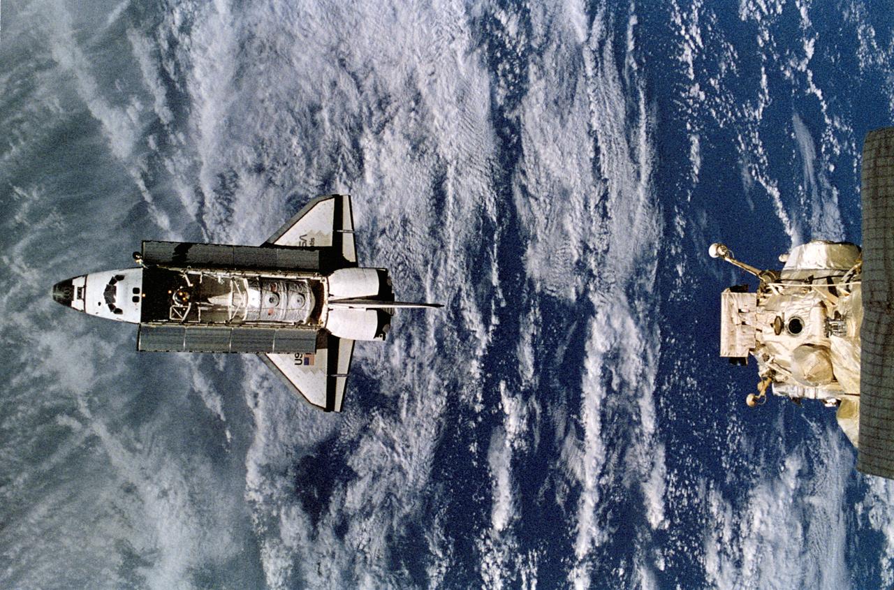 NM18-309-026 (28 June 1995) --- The Space Shuttle Atlantis approaches the docking node on the Kristall module of Russia's Mir Space Station. The photograph was taken by one of the Mir-18 crew members aboard Mir prior to rendezvous and docking of the two spacecraft. The Spacelab Science Module and the tunnel connecting it to the crew cabin, as well as the added mechanism for interface with the Mir's docking system can be easily seen.