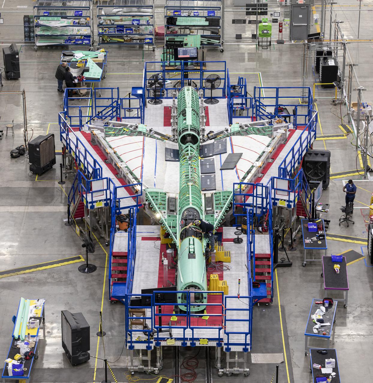 This overhead view shows NASA’s X-59 Quiet SuperSonic Technology or QueSST aircraft as it comes together for the merger of its main parts – the wing, forward section and tail assembly.  Lockheed Martin Photography By Garry Tice 1011 Lockheed Way, Palmdale, Ca. 93599 Event: Manufacturing Area From Above Date: 5/26/2021