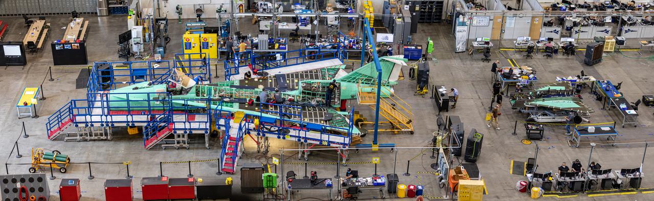 This overhead view of the X-59 shows the aircraft’s current state of assembly at Lockheed Martin Skunk Works in Palmdale, California. Throughout the manufacturing process, the team often removes components to effectively and safely assemble other sections of the aircraft. The X-59’s horizontal tails and lower empennage were recently removed from the aircraft and can be seen behind it as the team prepares for the installation of the engine. The X-59 is the centerpiece of the Quesst mission which plans to help enable commercial supersonic air travel over land.
