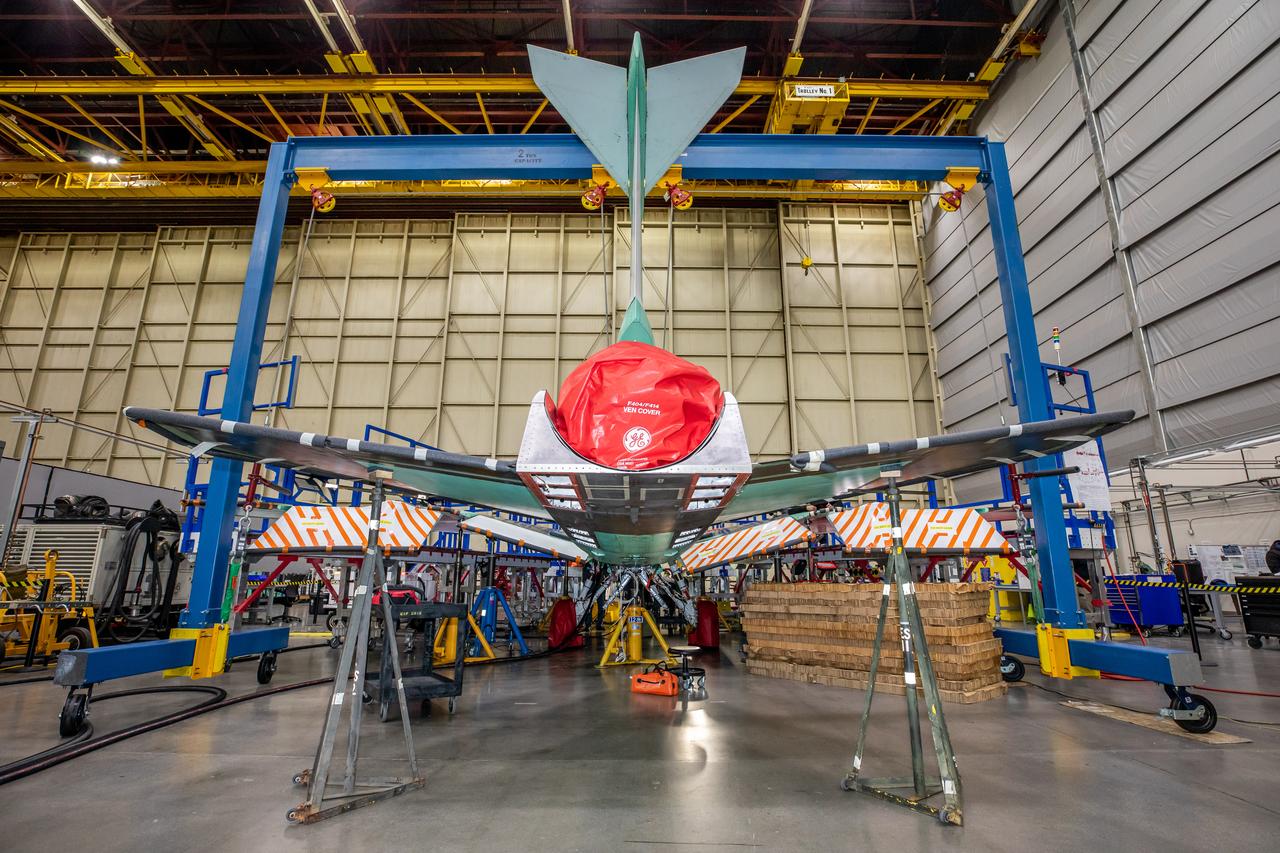 NASA’s X-59 sits in support framing while undergoing the installation of its lower empennage, or tail section, at Lockheed Martin Skunk Works in Palmdale, California in late March. 