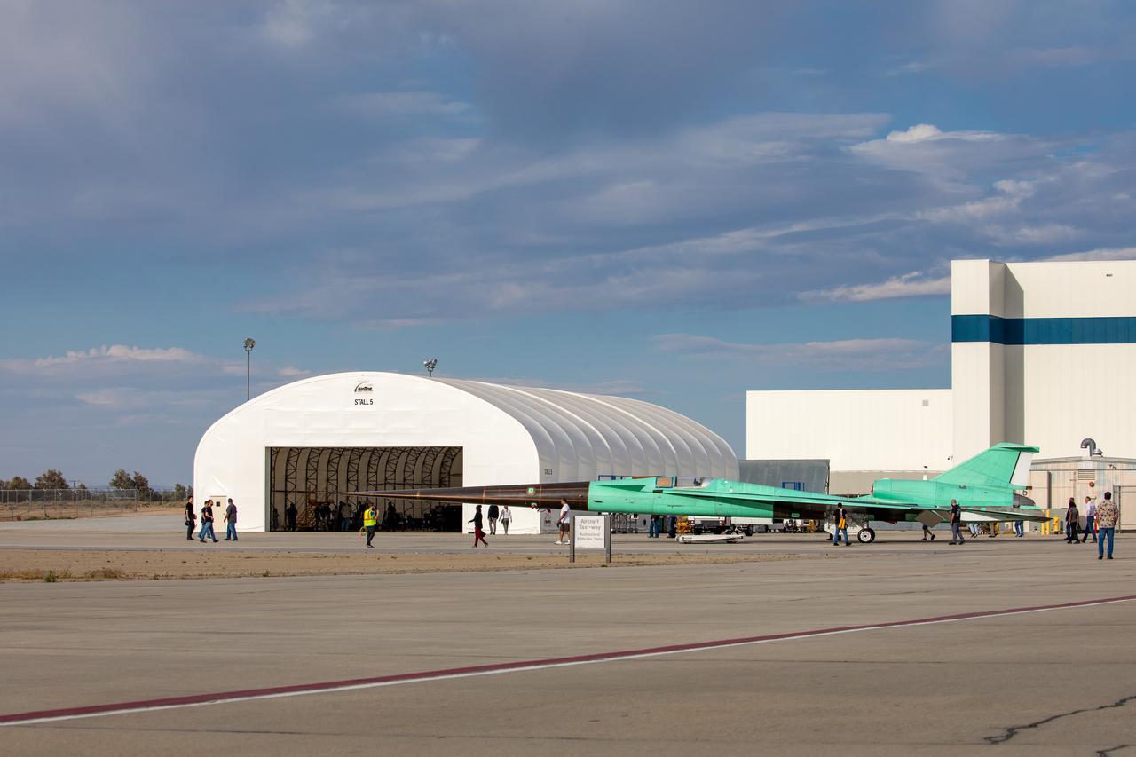 Technicians check out the X-59 aircraft as it sits near the runway at Lockheed Martin Skunk Works in Palmdale, California, on June 19, 2023.  Lockheed Martin Photography By Garry Tice 1011 Lockheed Way, Palmdale, Ca. 93599 Event: Move to Run Stall 5 Date: 6/19/2023 Additional Info: