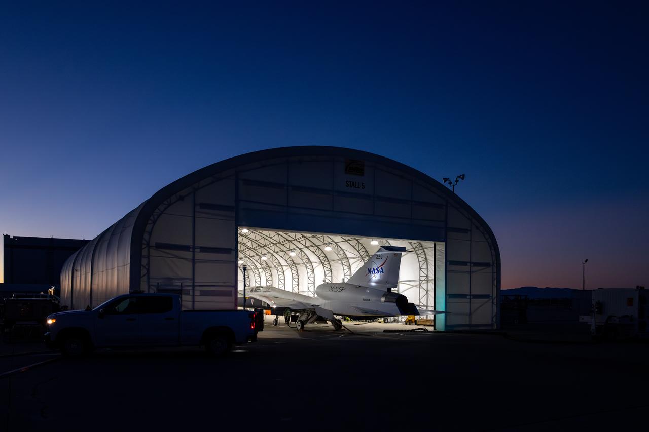 NASA’s X-59 quiet supersonic research aircraft sits inside its run stall following maximum afterburner testing at Lockheed Martin’s Skunk Works facility in Palmdale, California. The test demonstrates the engine’s ability to generate the thrust required for supersonic flight, advancing NASA’s Quesst mission. The X-59 is the centerpiece of the mission, designed to demonstrate quiet supersonic flight over land, addressing a key barrier to commercial supersonic travel.