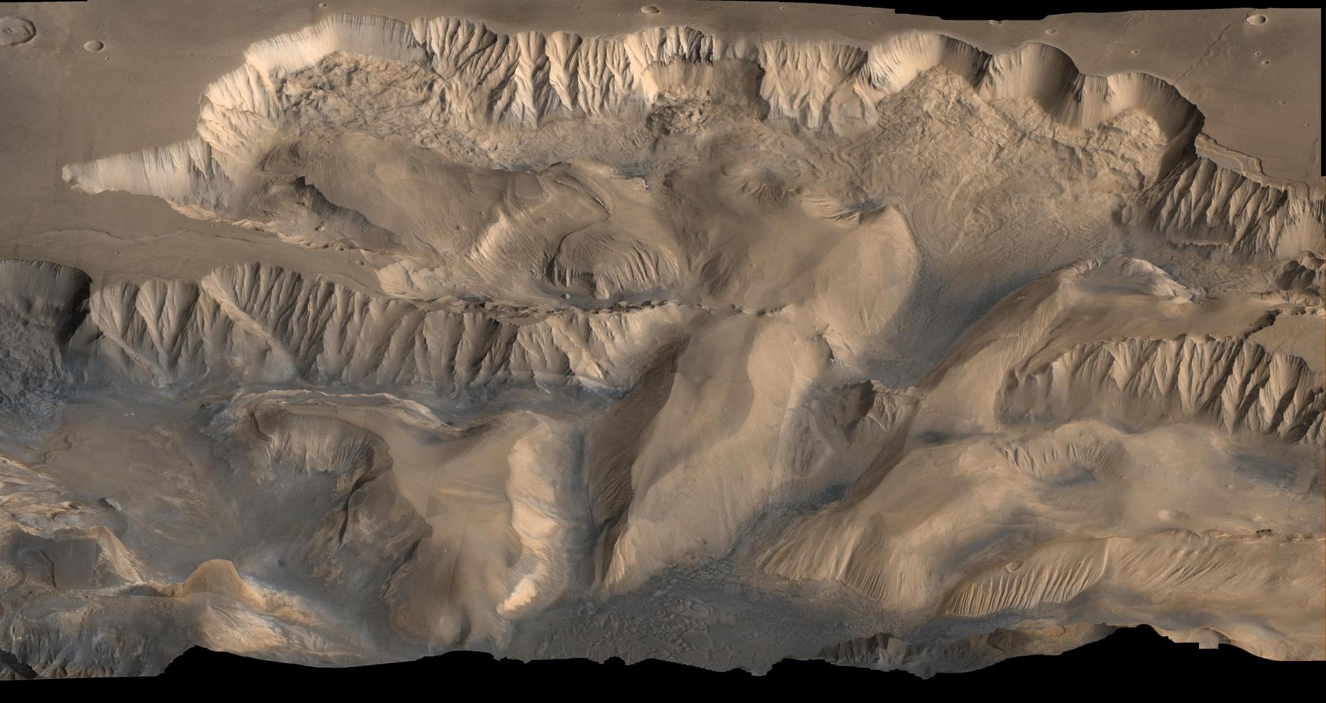 An oblique, color image of central Valles Marineris, Mars showing relief of Ophir and Candor Chasmata; view toward north. The photograph is a composite of Viking high-resolution images in black and white and low-resolution images in color.