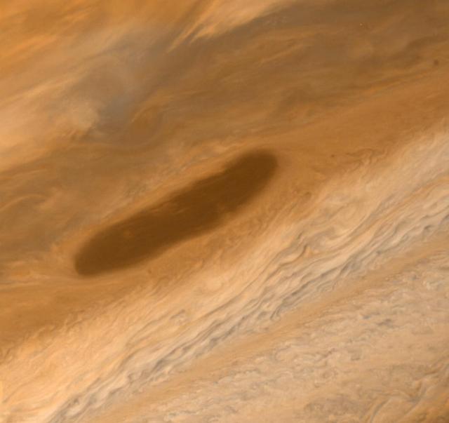 This large brown oval, photographed on Mar. 2, 1979 by NASA Voyager 1. Features of this sort are not rare on Jupiter and have an average lifetime of one to two years. Above the feature is the pale orange North Temperate Belt.  http://photojournal.jpl.nasa.gov/catalog/PIA00015