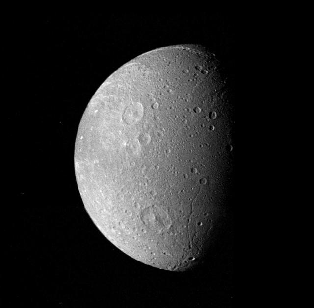 Many impact craters -- the record of the collision of cosmic debris -- are shown in this mosaic from NASA Voyager 1 of Saturn moon Dione.