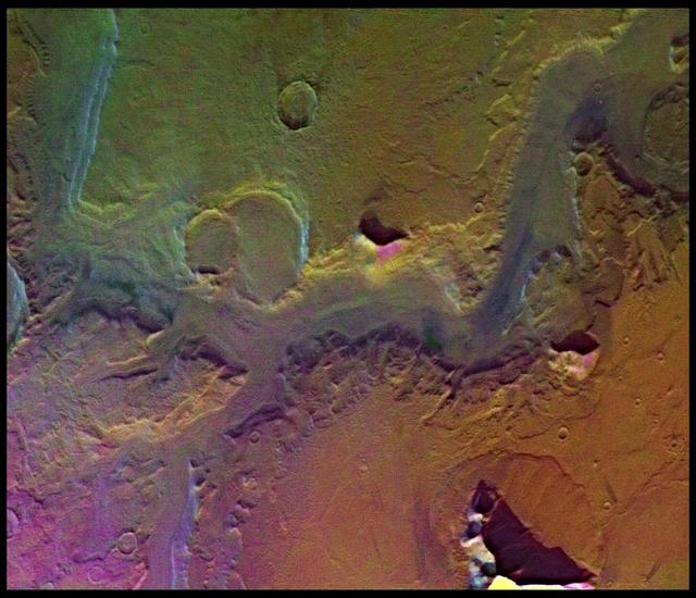 A conspicuous fretted channel, Reull Valles, Mars which dissects wall deposits of the large Hellas impact basin, trends southeast towards the basin floor as seen by NASA's Viking Orbiter 2. http://photojournal.jpl.nasa.gov/catalog/PIA00154