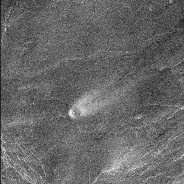 This comet-like tail, trending northeast from the volcanic structure, is a relatively radar-bright deposit. The volcano, with a base diameter of about 3 miles, is a local topographic high point that has slowed down northeast trending winds.  http://photojournal.jpl.nasa.gov/catalog/PIA00243