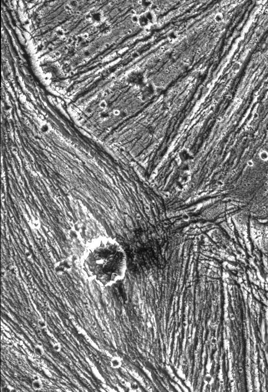 A mixture of terrains studded with a large impact crater is shown in this view of the Uruk Sulcus region of Jupiter moon Ganymede taken by NASA Galileo spacecraft during its first flyby of the planet-sized moon on June 27, 1996.  http://photojournal.jpl.nasa.gov/catalog/PIA00280