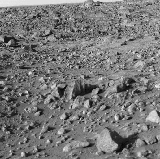 NASA's Viking 1 took this high-resolution picture today, its third day on Mars. Distance from the camera to the nearfield (bottom) is about 4 meters (13 feet); to the horizon, about 3 kilometers (1.8 miles). The photo shows numerous angular blocks ranging in size from a few centimeters to several meters. The surface between the blocks is composed of fine-grained material. Accumulation of some fine-grained material behind blocks indicates wind deposition of dust and sand downwind of obstacles. The large block on the horizon is about 4 meters (13 feet) wide. Distance across the horizon is about 34 meters (110 feet).  http://photojournal.jpl.nasa.gov/catalog/PIA00385