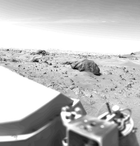 This Mars view looks northeast from Nasa's Viking 1 and completes the 360 panorama of the landing site begun earlier with the spacecraft's other camera. A layer of haze can be seen in the Martian sky. Large dark boulders dominate the scene. The largest boulder (center) is about 3 meters (10 feet) wide and one meter (3 feet) high. Rocks in the foreground are lighter and appear mottled. The rocks may have been derived from lava flows or stream deposits which are visible on orbiter images. These deposits may have been redistributed by impact craters. The fine material visible between the rocks has dune morphology and appears to have been deposited by wind.  http://photojournal.jpl.nasa.gov/catalog/PIA00387